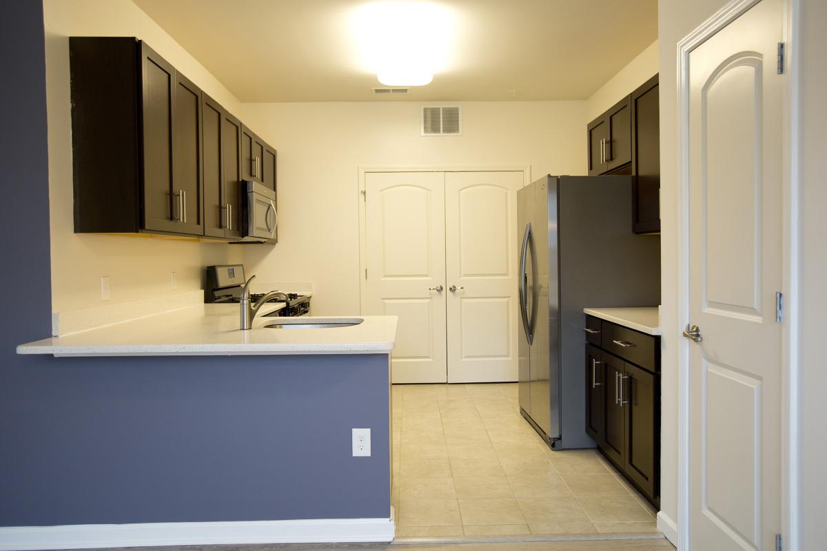 a kitchen with a sink and a refrigerator