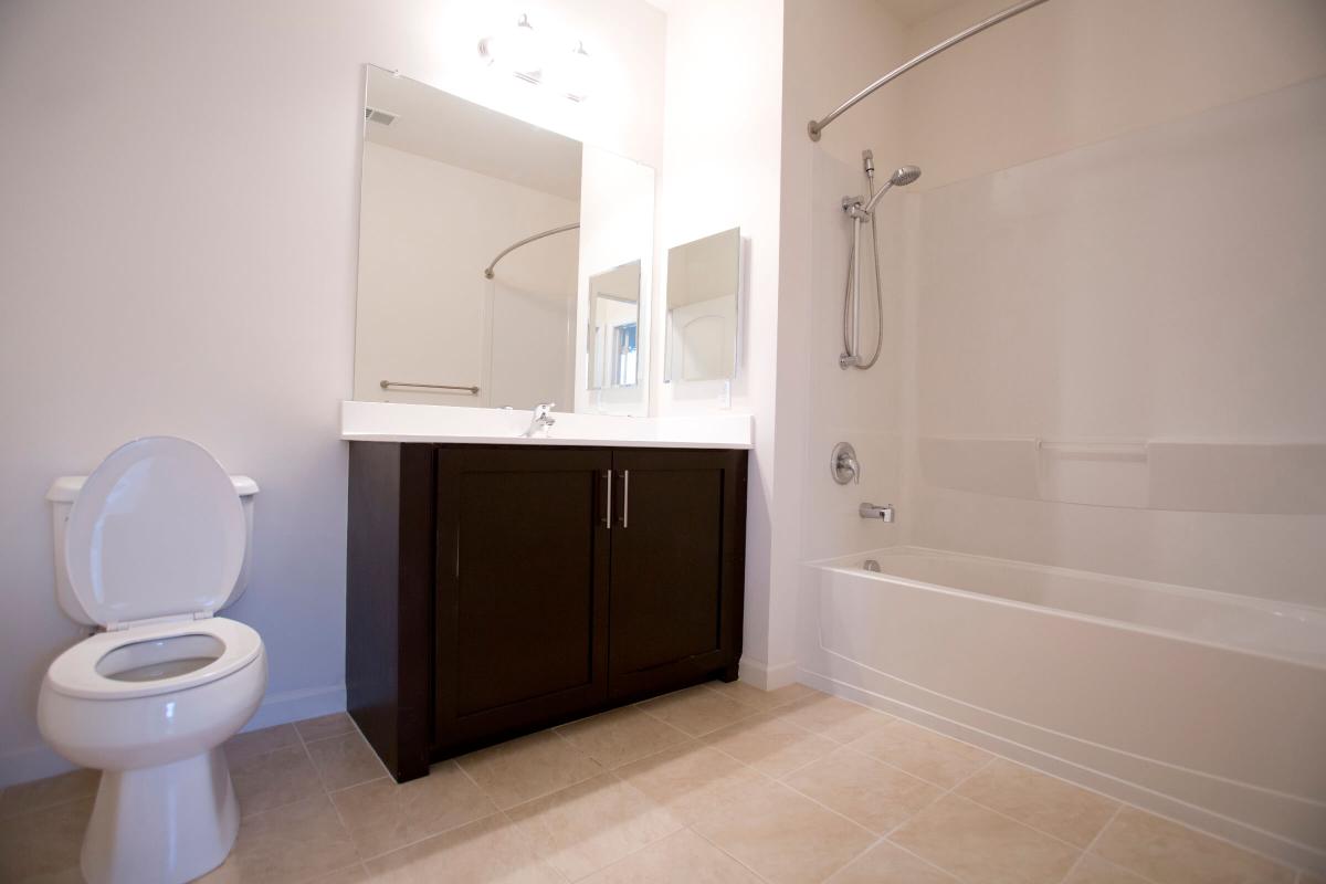 a large white tub next to a sink