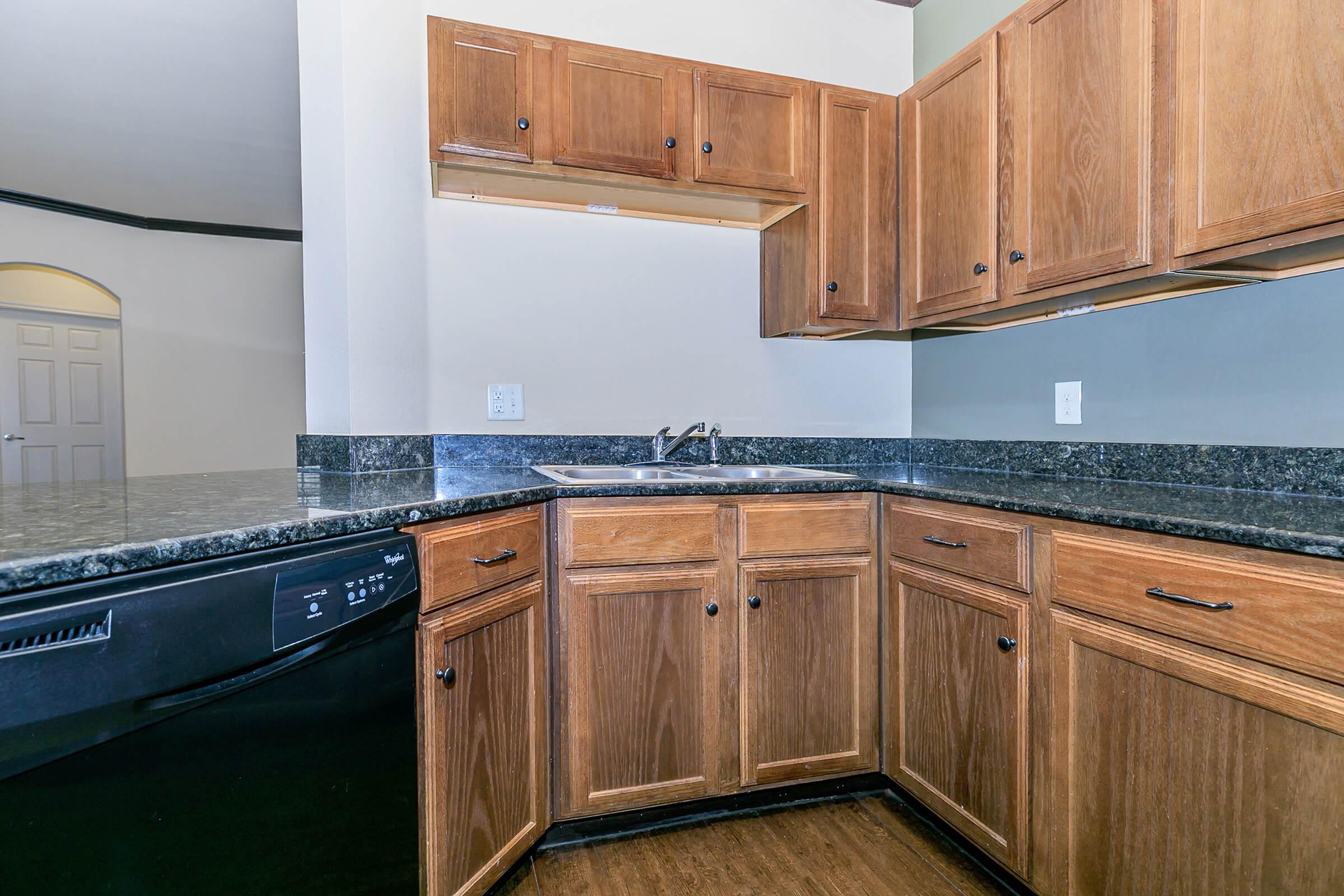 a kitchen with wooden cabinets