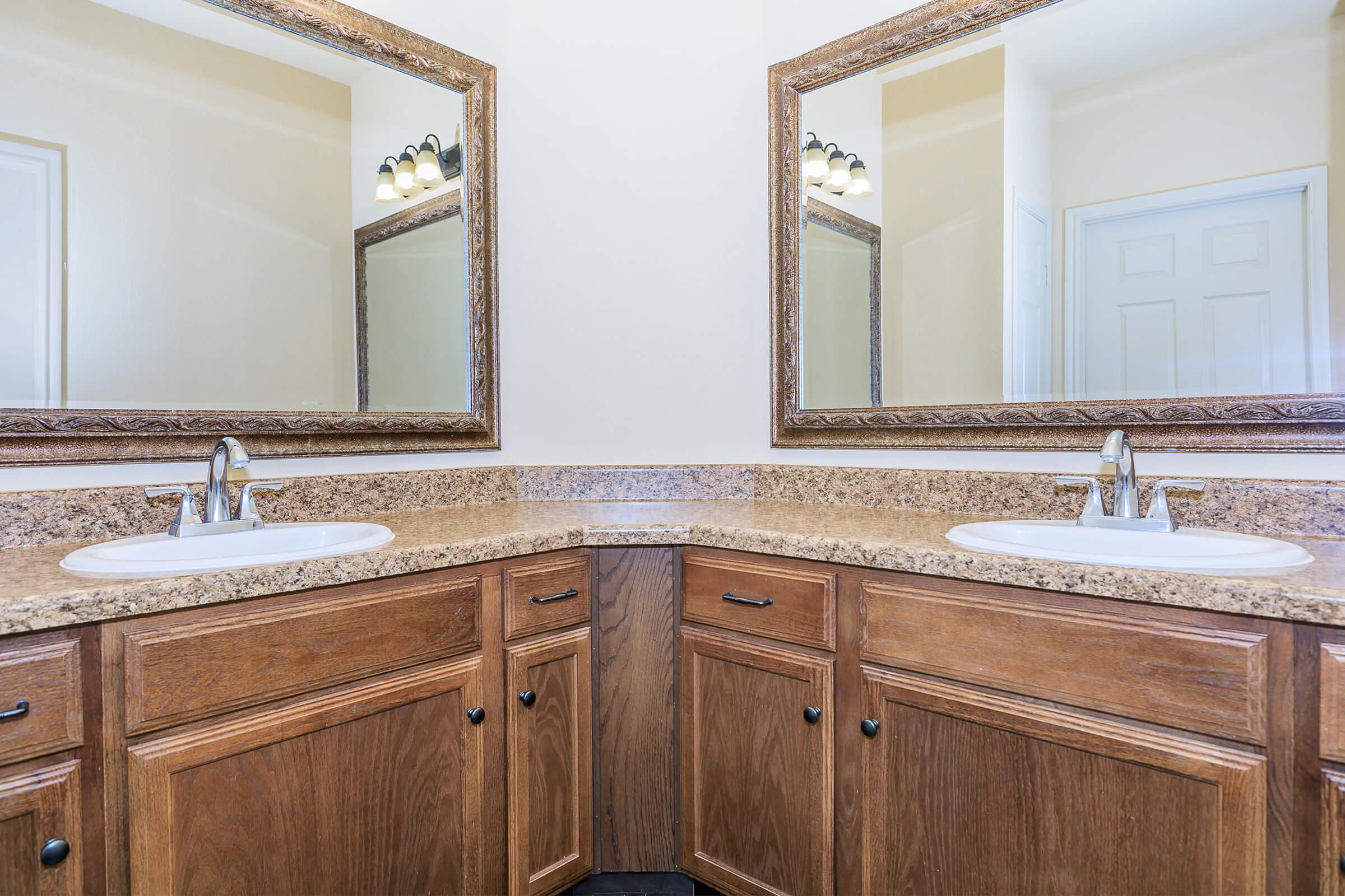 a kitchen with a sink and a mirror