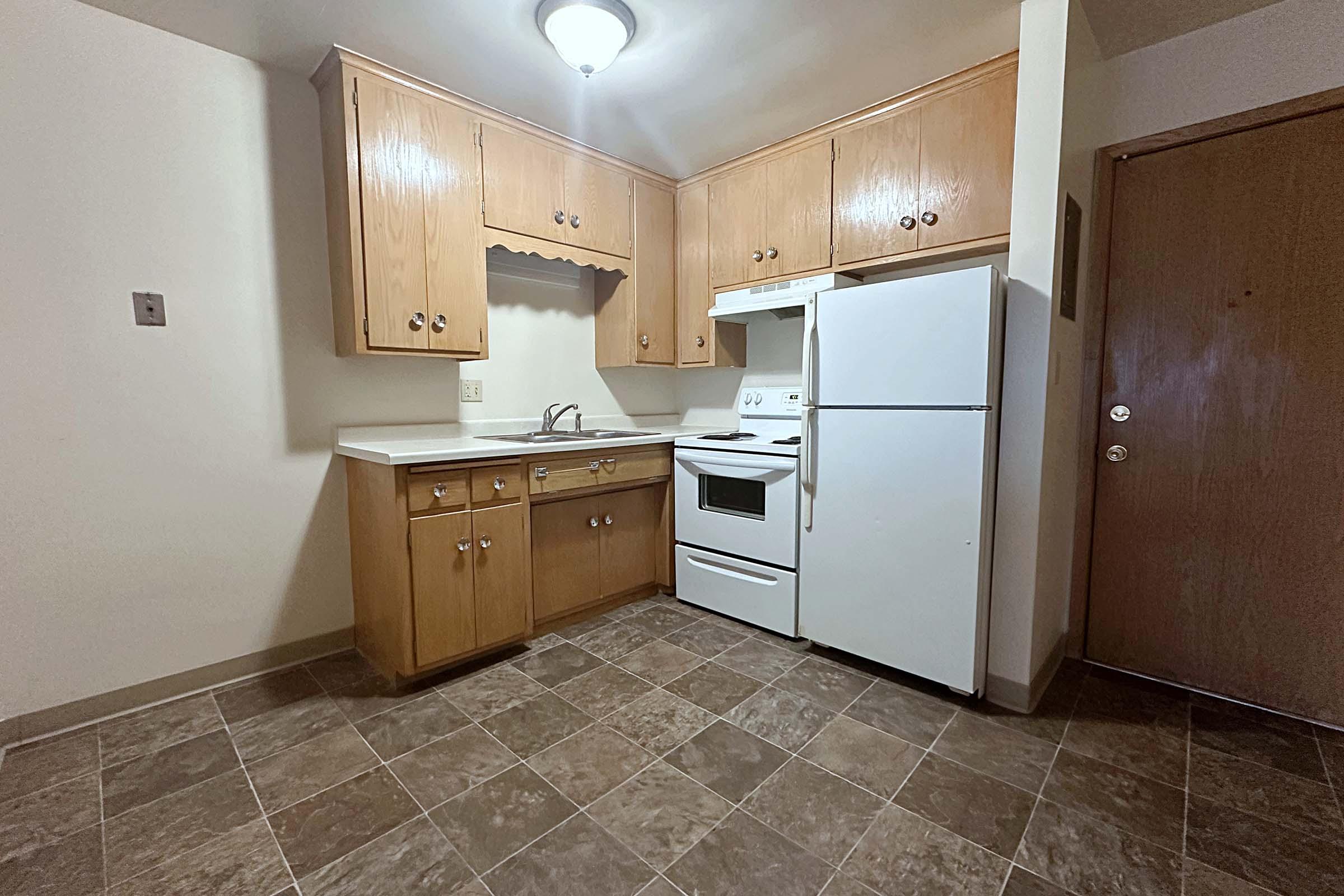 a kitchen with a sink and a refrigerator