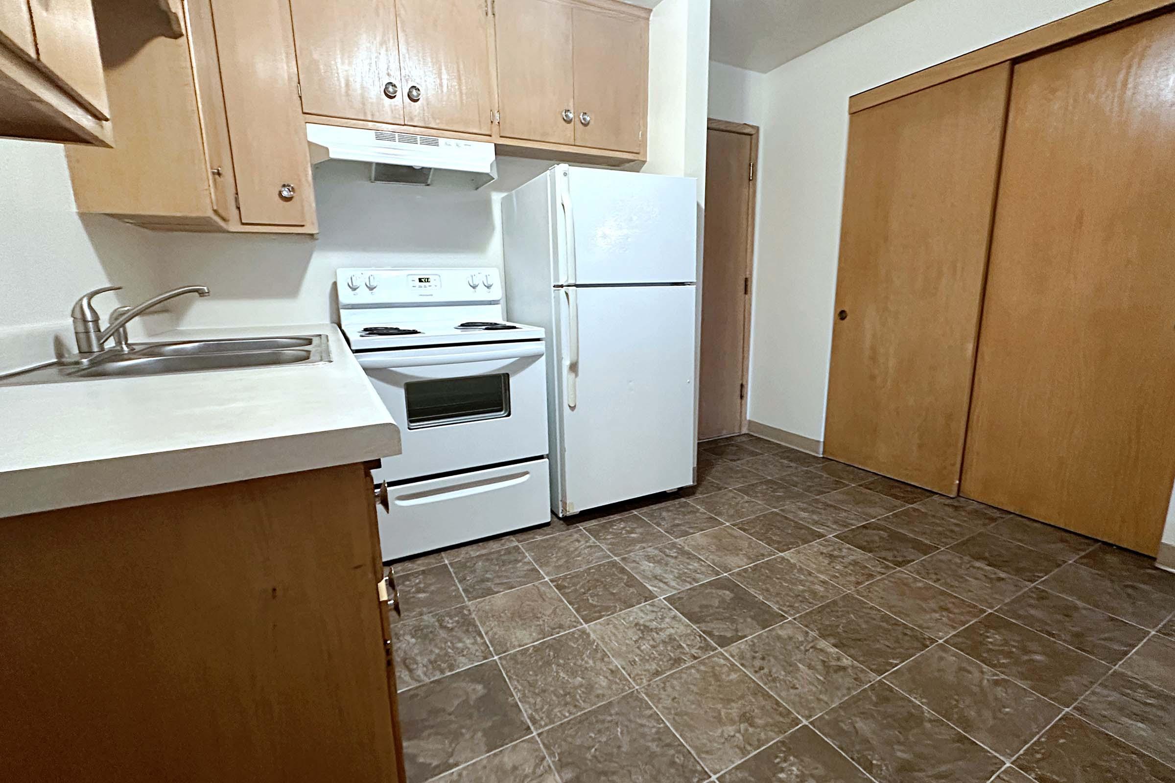 a stove top oven sitting inside of a kitchen