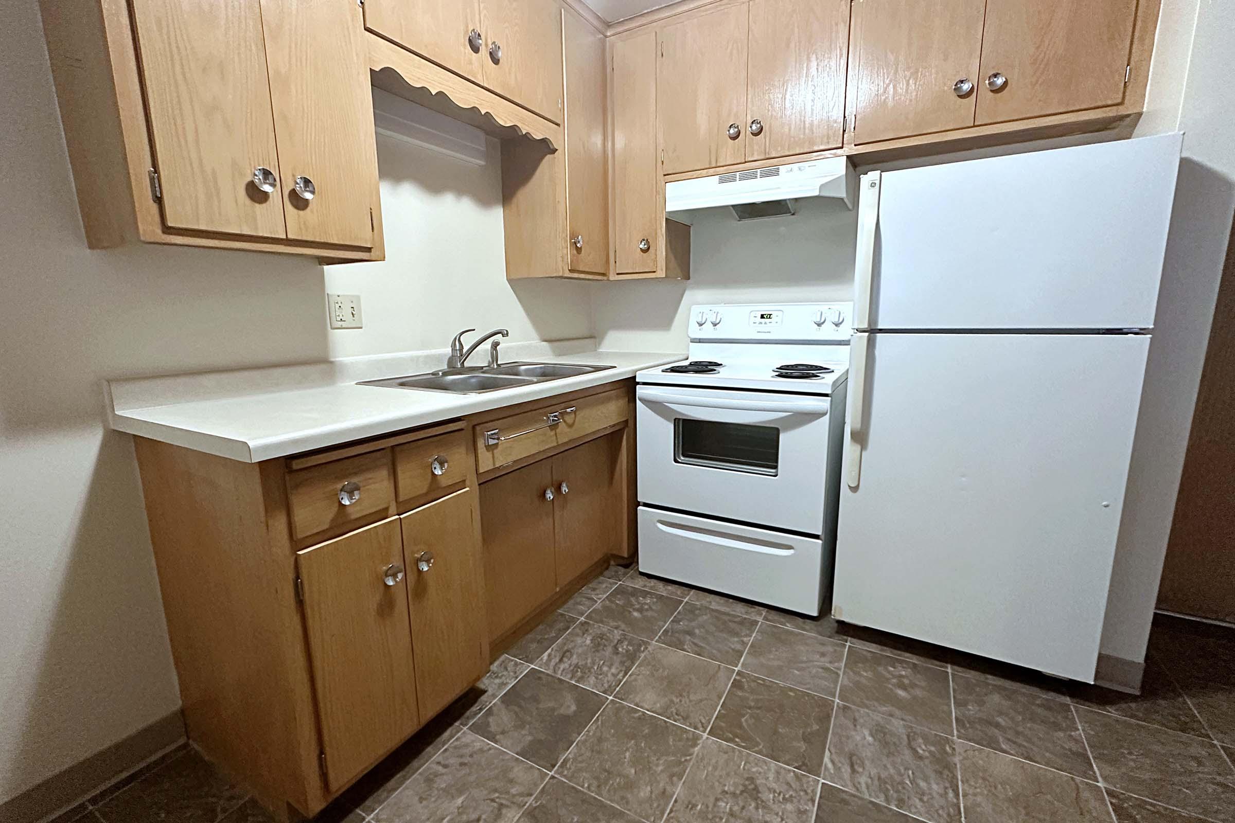 a stove top oven sitting inside of a kitchen