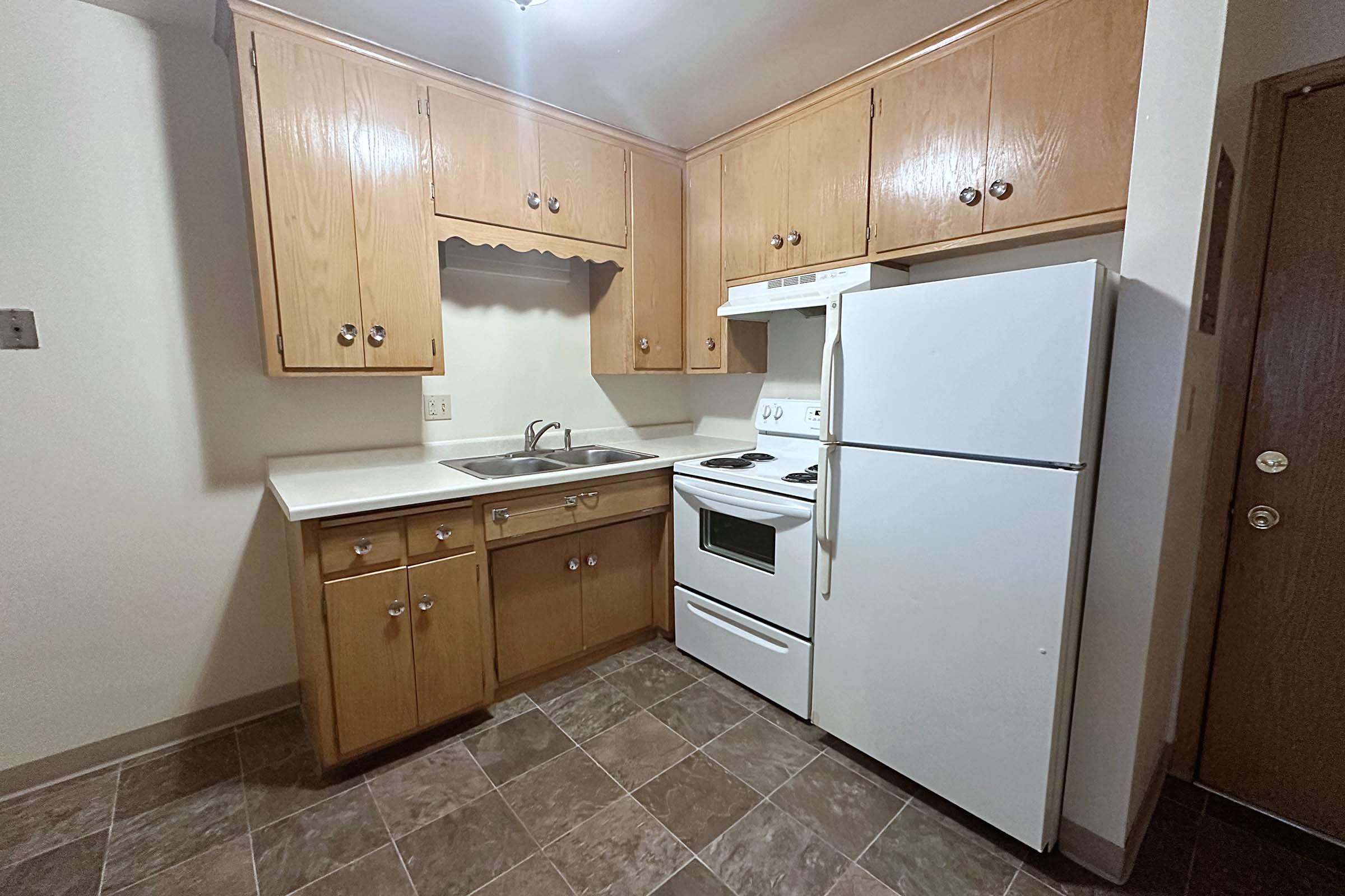 a kitchen with a sink and a refrigerator