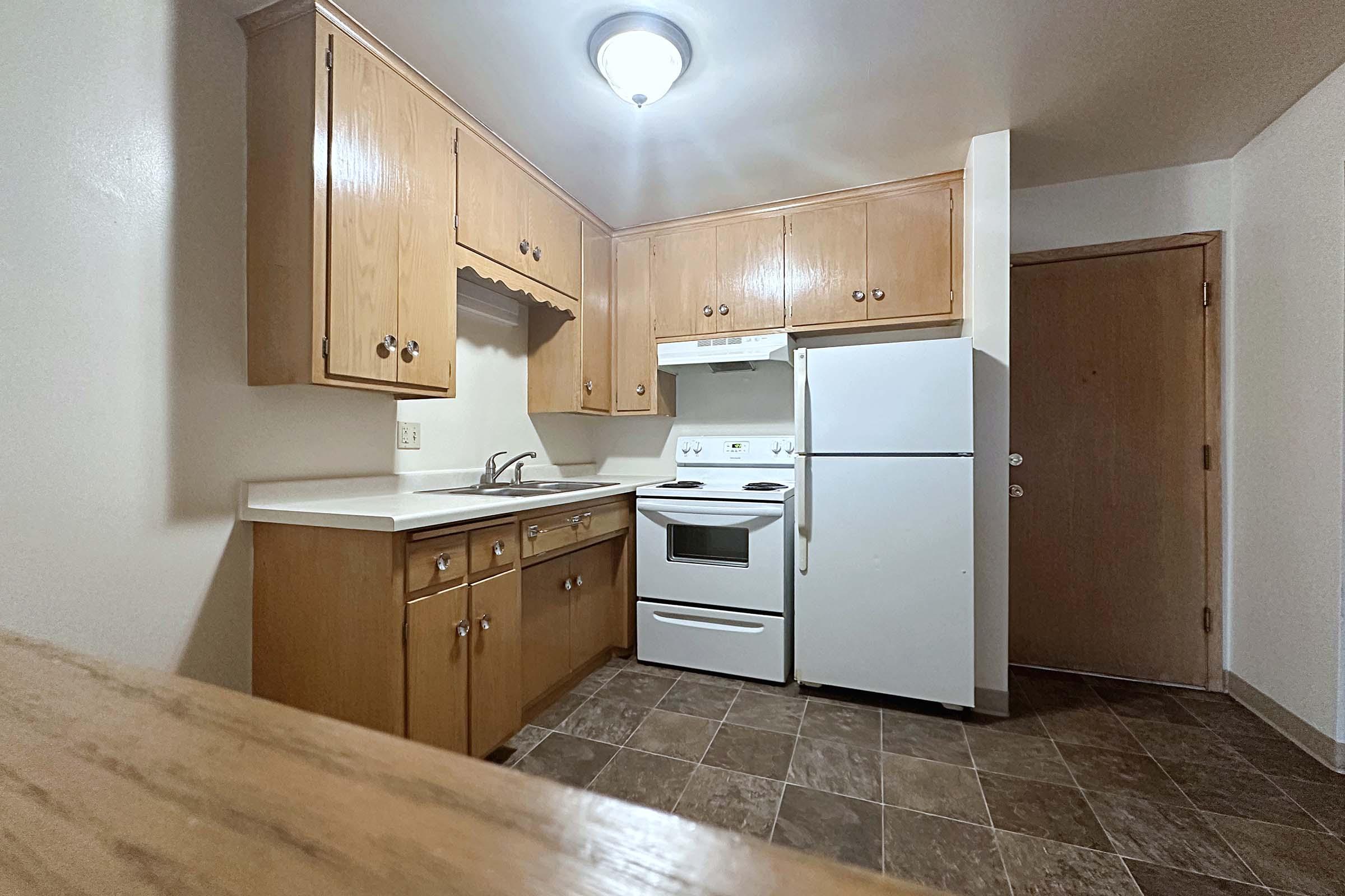 a kitchen with a stove and a refrigerator