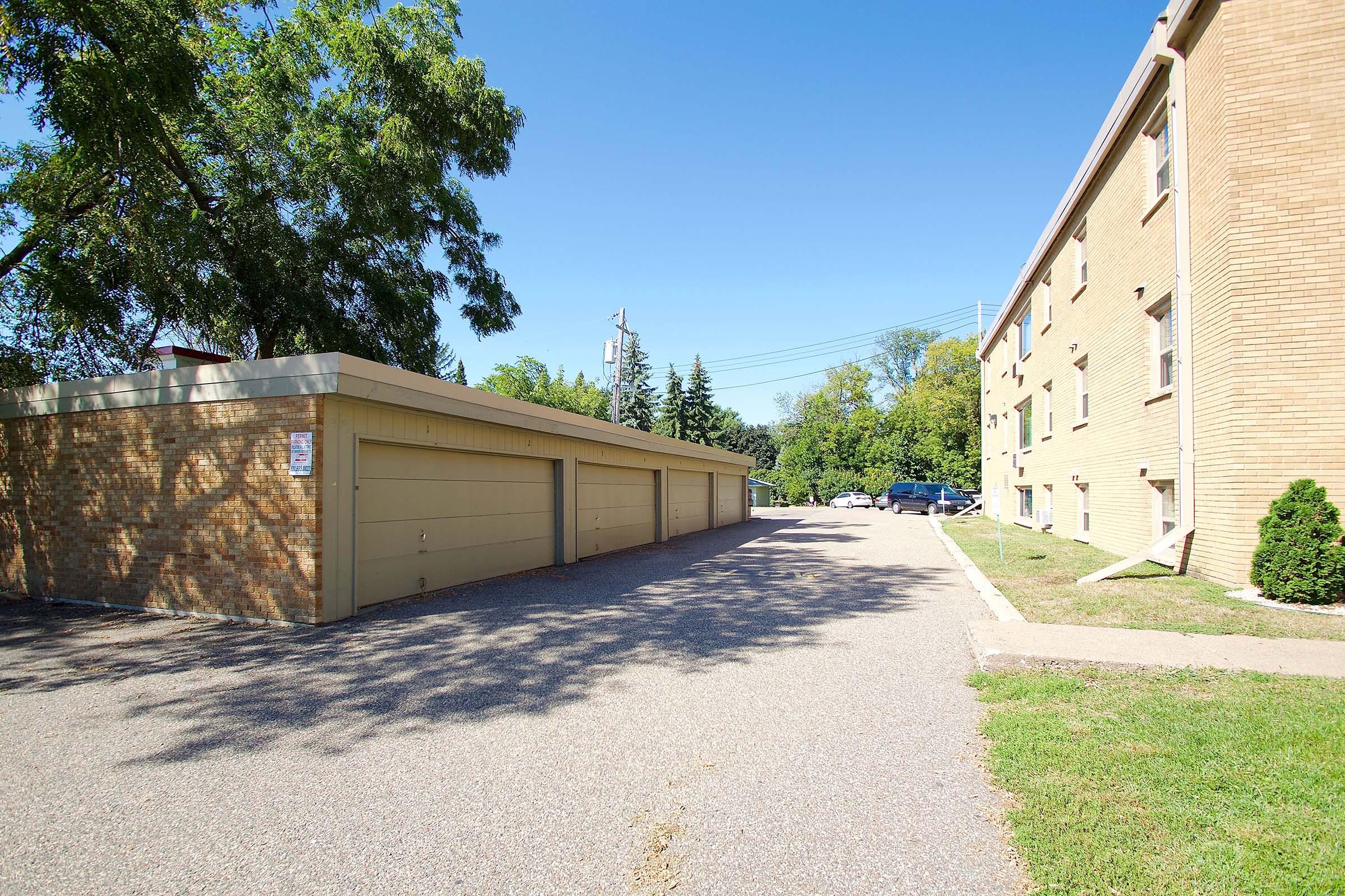 a path with trees on the side of a building