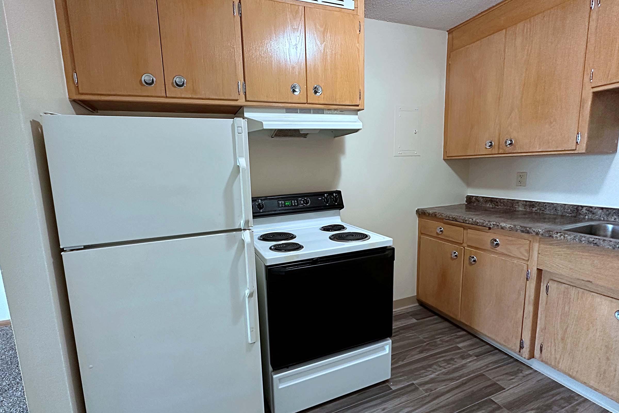 a kitchen with a stove top oven sitting inside of a refrigerator