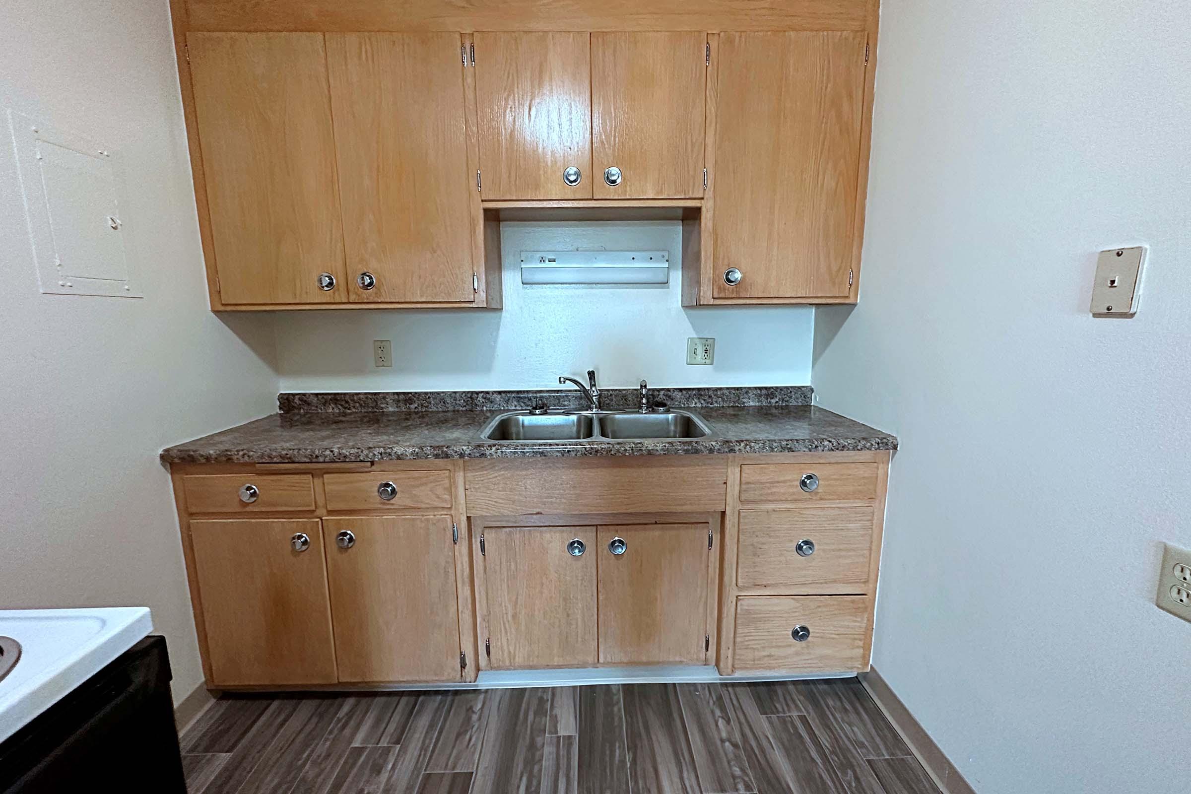 a kitchen with wooden cabinets