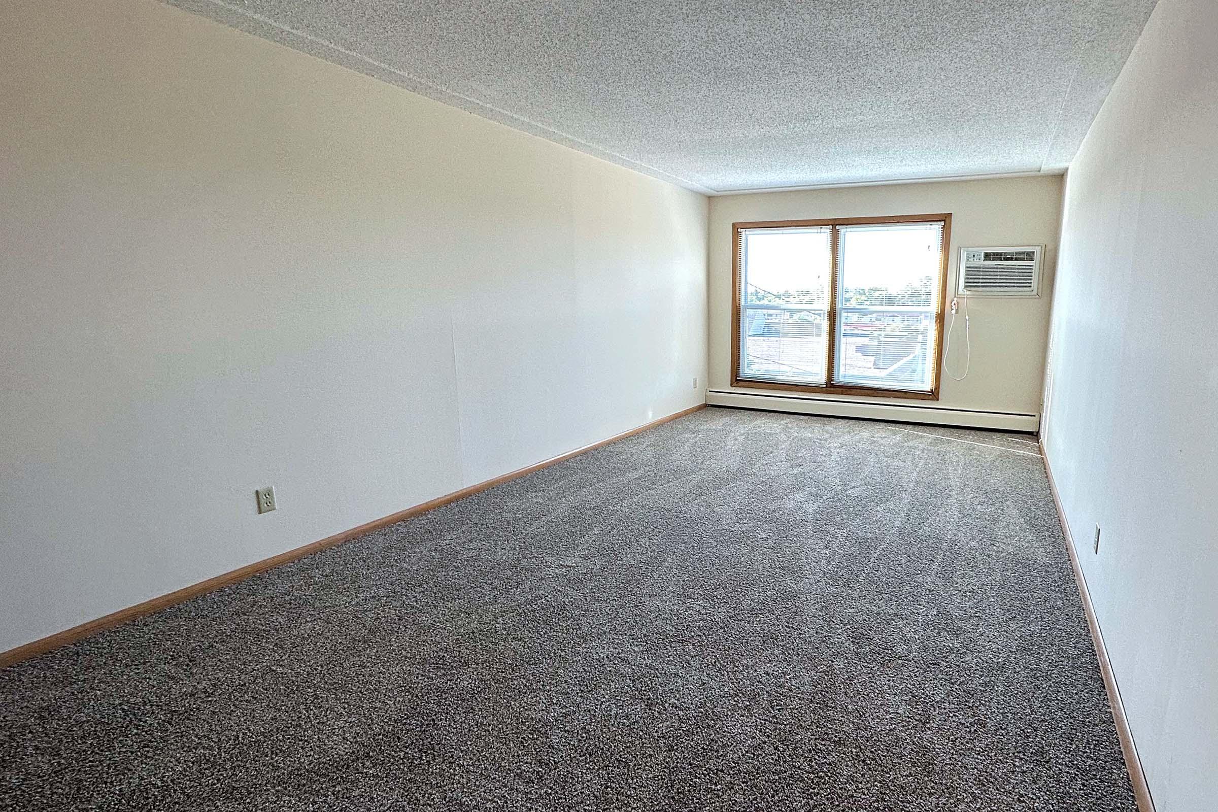 a bedroom with a large window