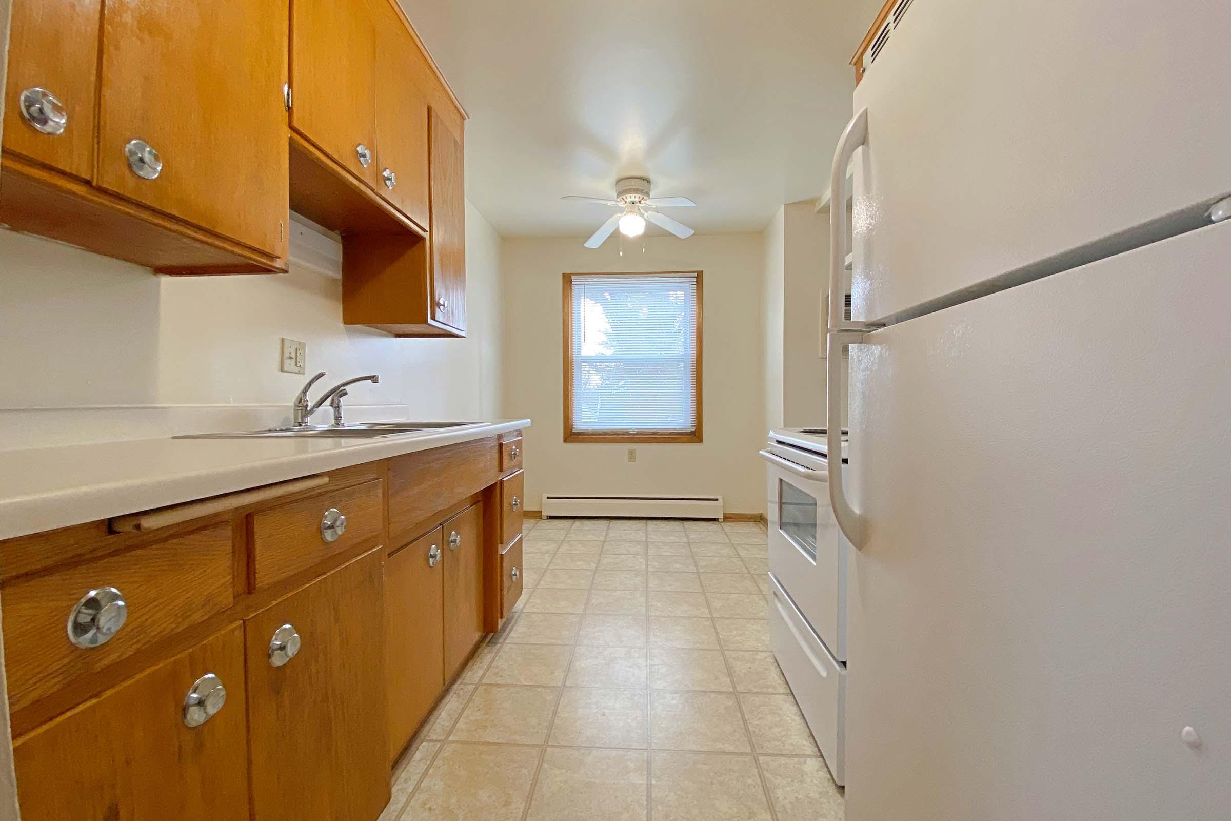 a kitchen with a sink and a refrigerator