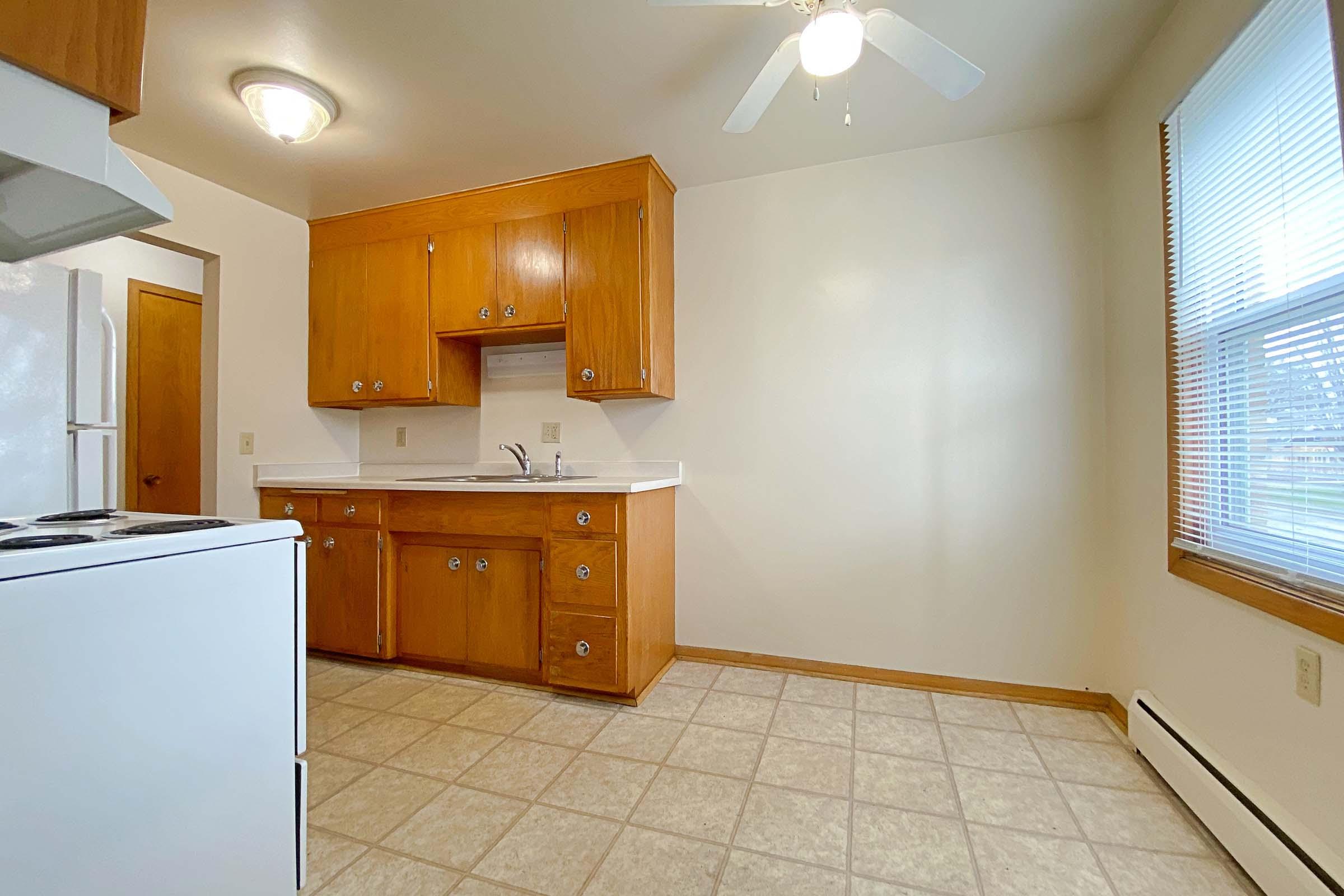 a kitchen with stainless steel appliances and wooden cabinets