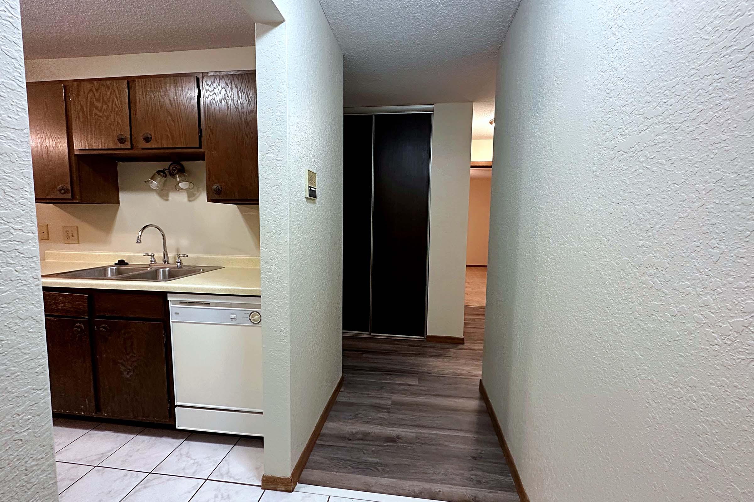 a kitchen with a sink and a mirror