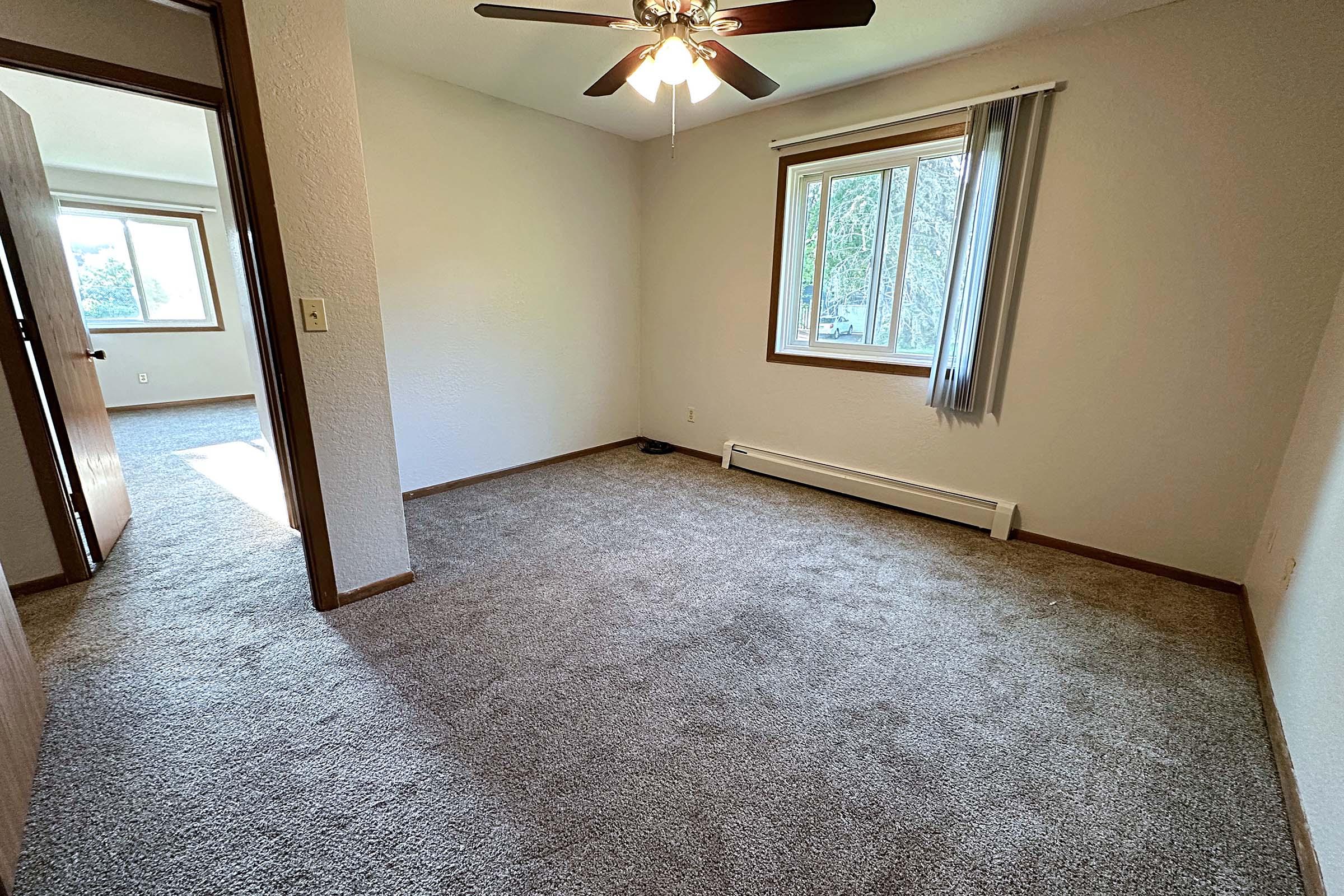 a room with a tiled floor next to a window