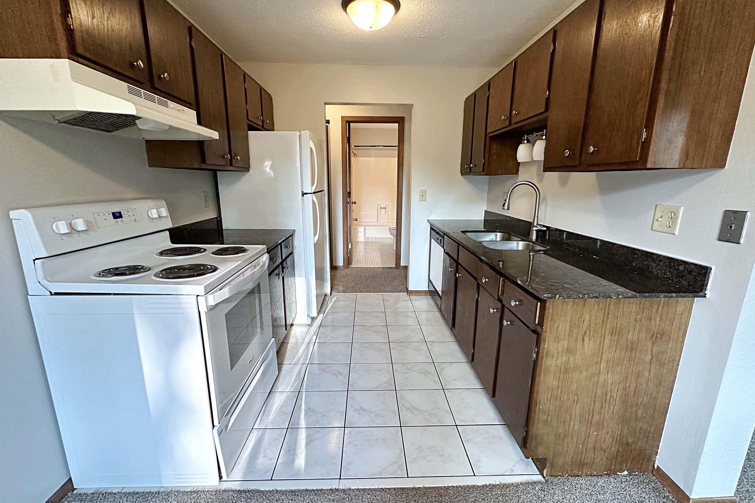 a stove top oven sitting inside of a kitchen