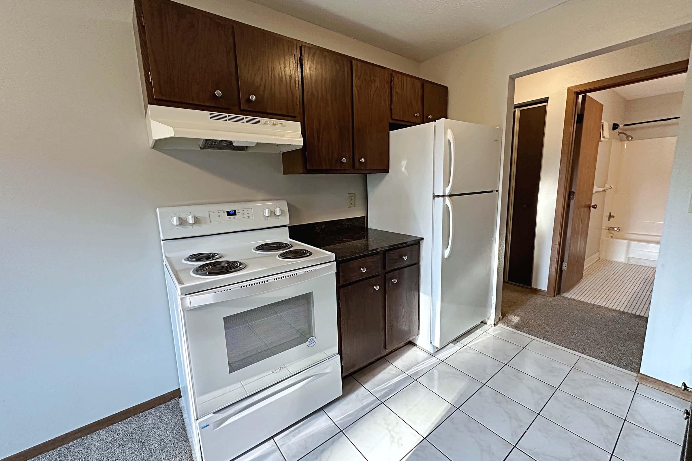 a stove top oven sitting inside of a kitchen