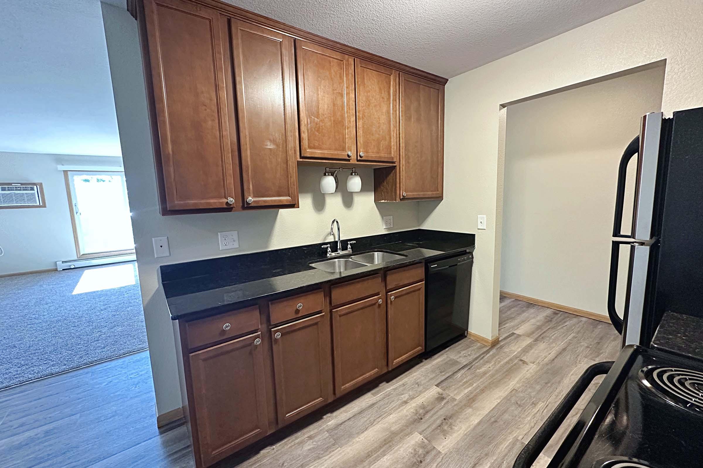 a kitchen with stainless steel appliances and wooden cabinets