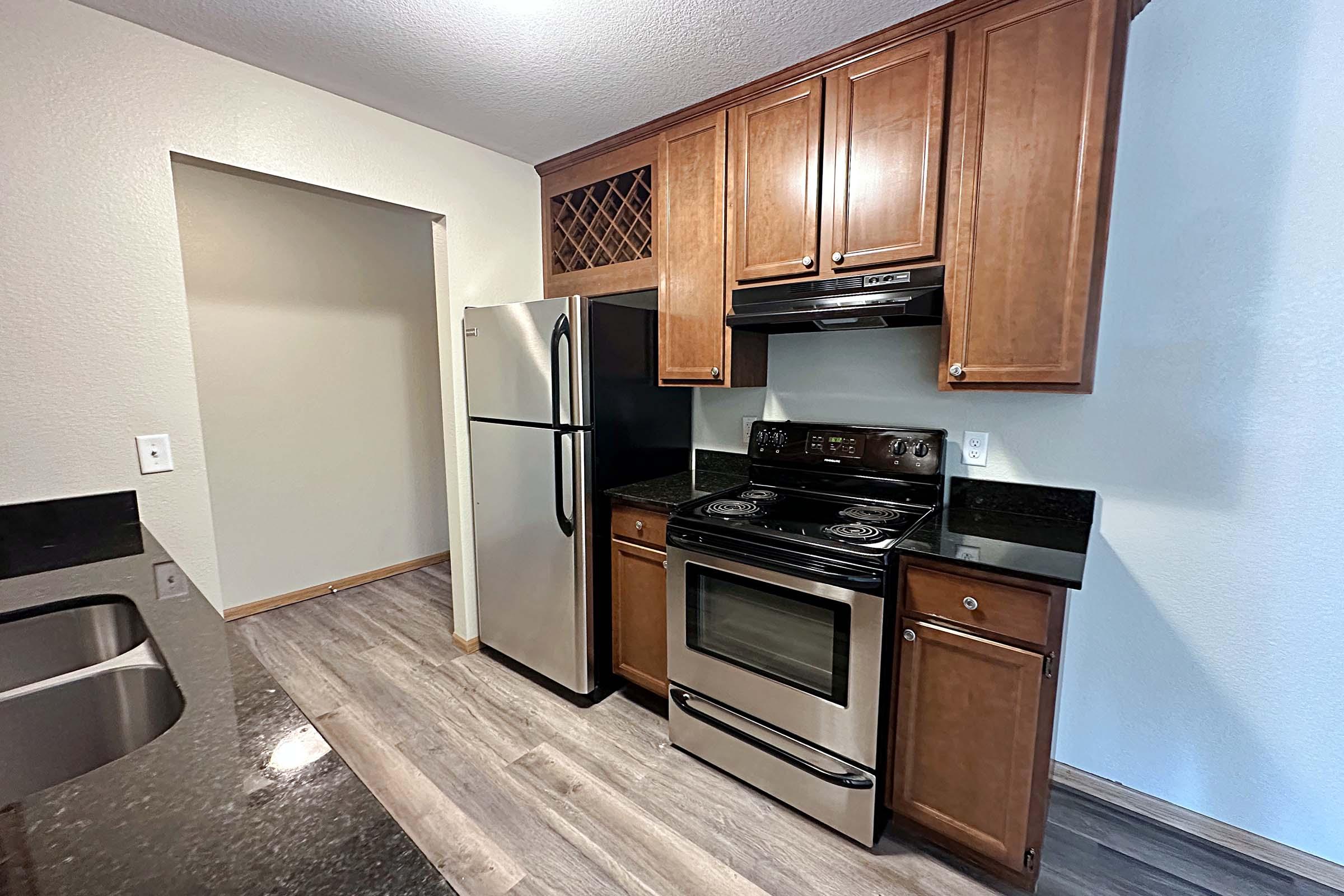 a kitchen with stainless steel appliances and wooden cabinets