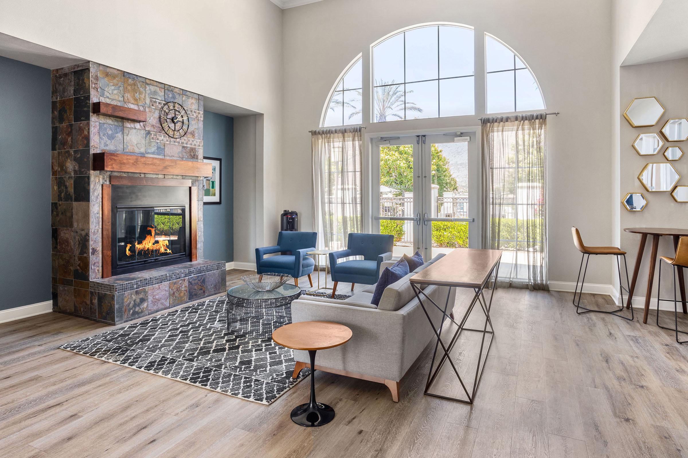 a living room filled with furniture and a large window