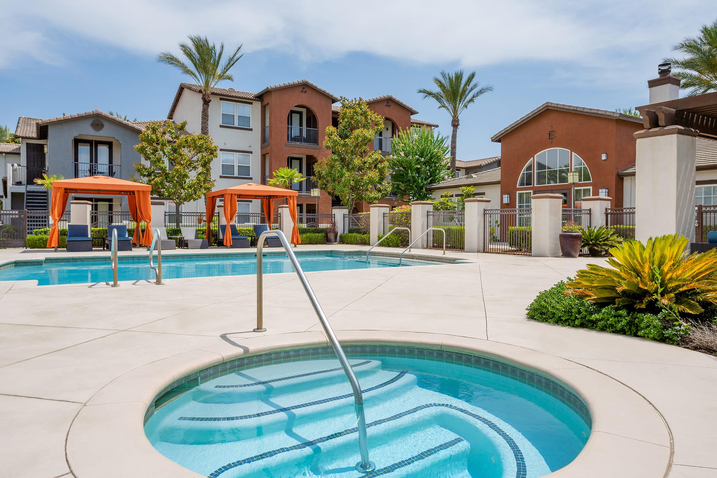 a house with a pool in front of a building