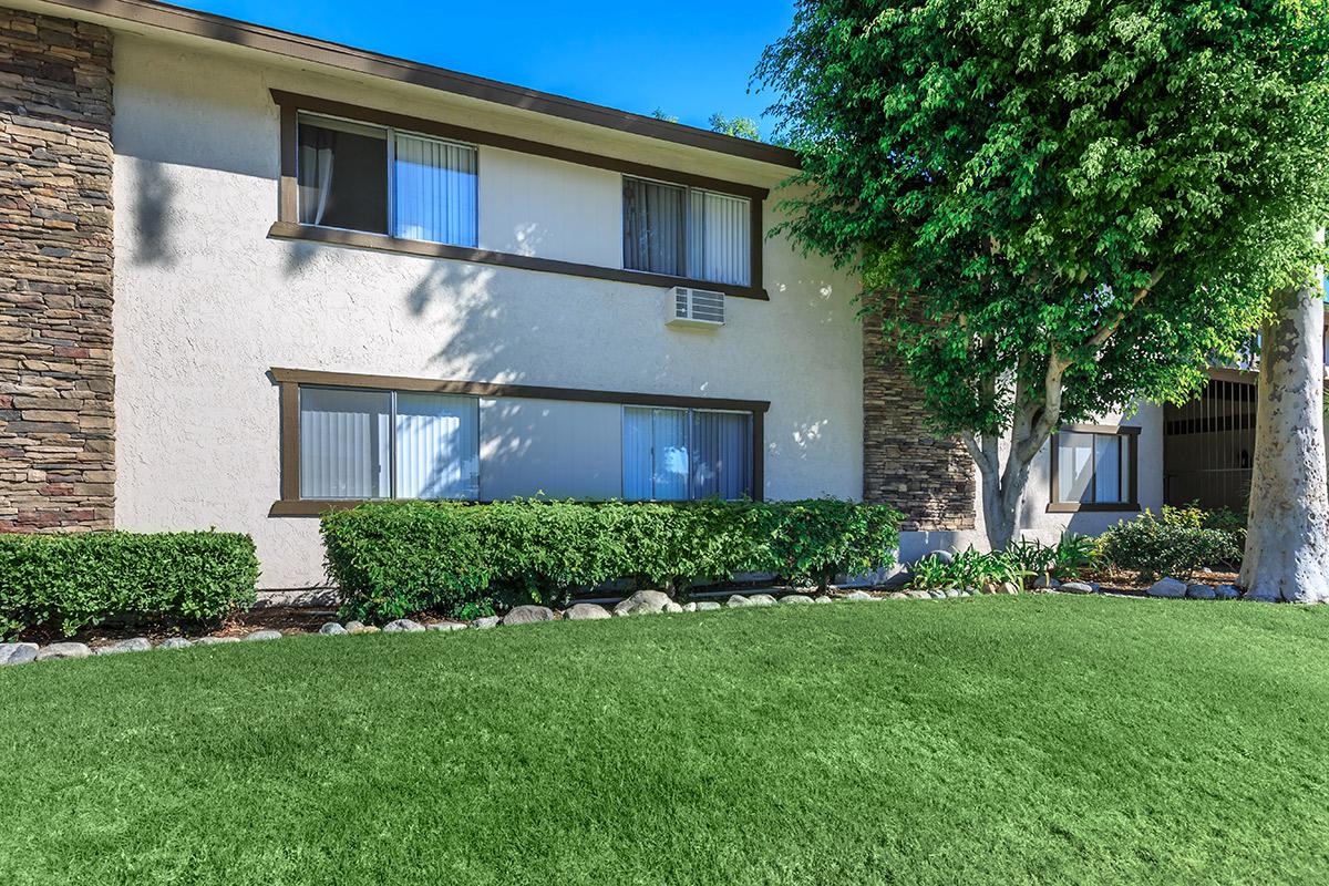 Singing Tree Apartment Homes community building with green grass