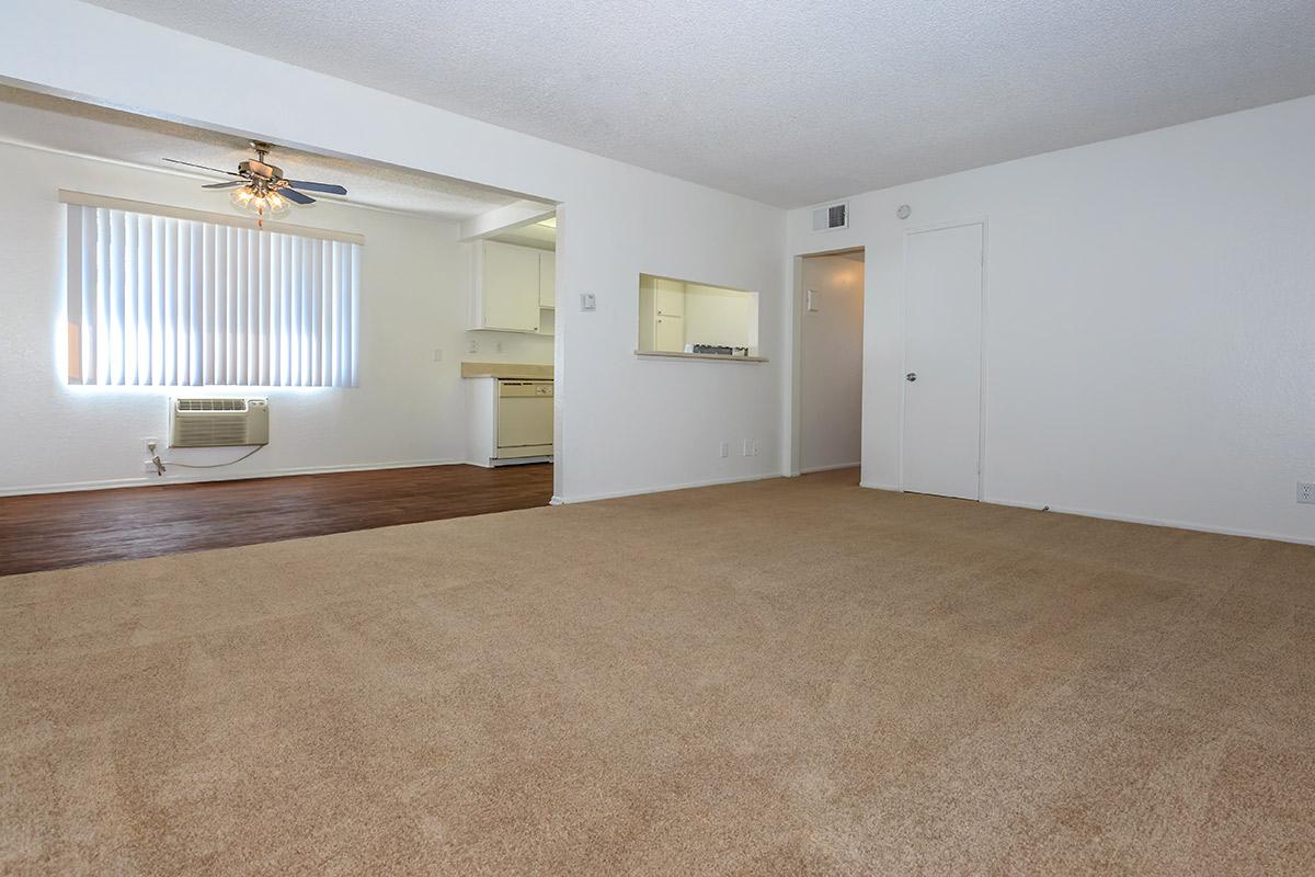 Carpeted living room and wooden floor dining room