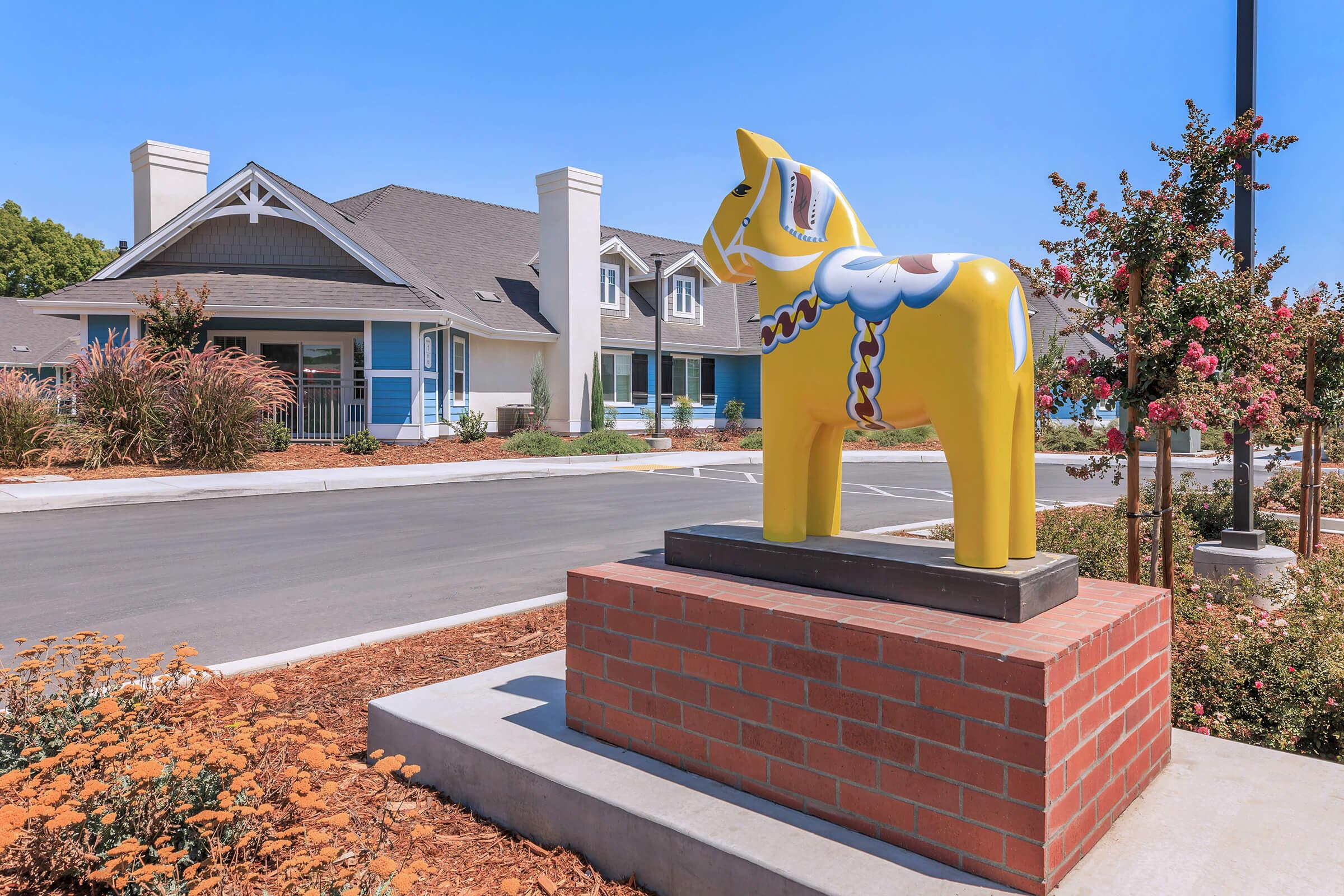 a statue in front of a brick building