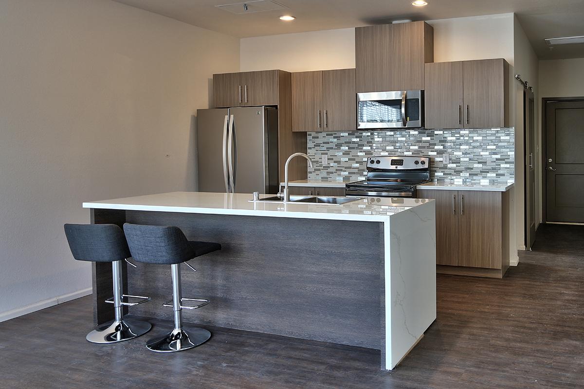 a kitchen with an island in the middle of a room