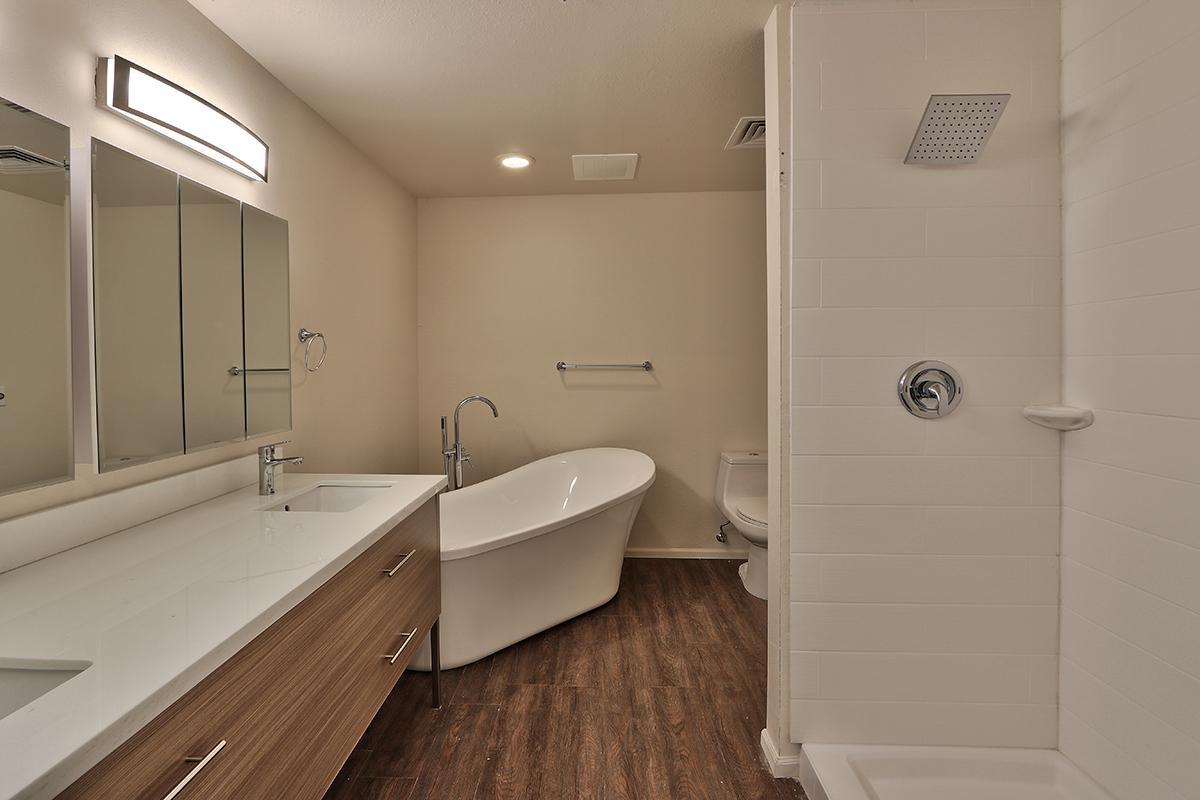 a large white tub sitting next to a sink