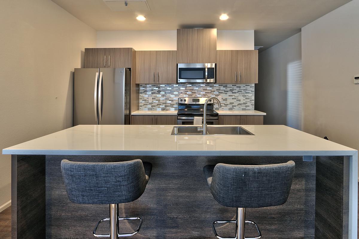 a modern kitchen with an island in the middle of a room