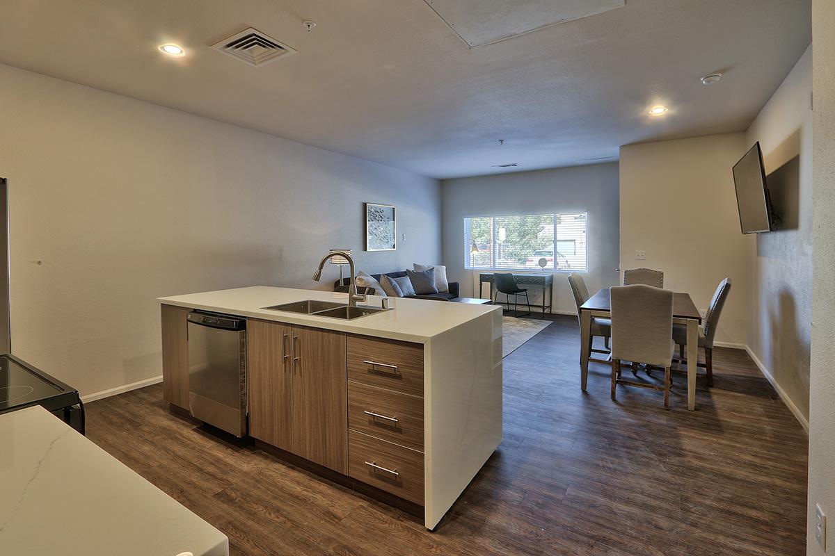 a kitchen with a wood floor in a room