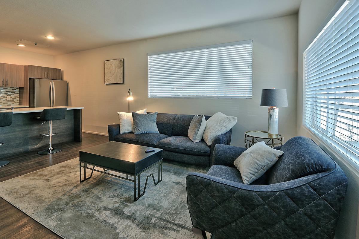 a living room filled with furniture and a large window