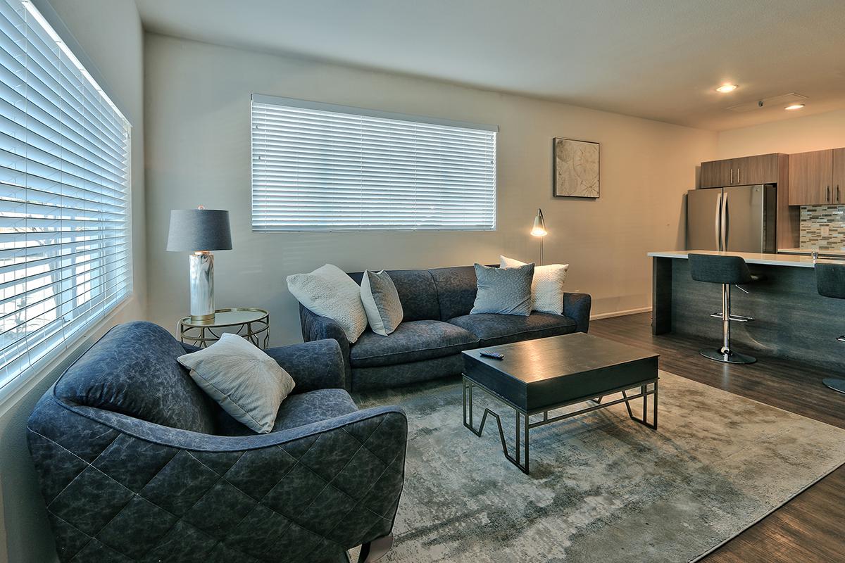 a living room filled with furniture and a large window