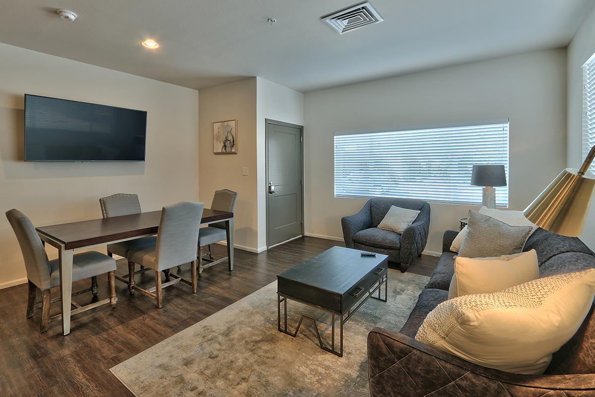 a living room filled with furniture and a large window