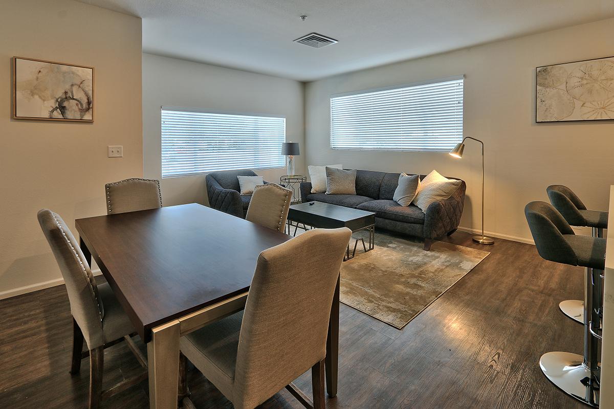 a living room filled with furniture and a large window