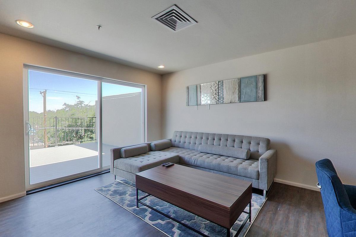 a living room filled with furniture and a large window