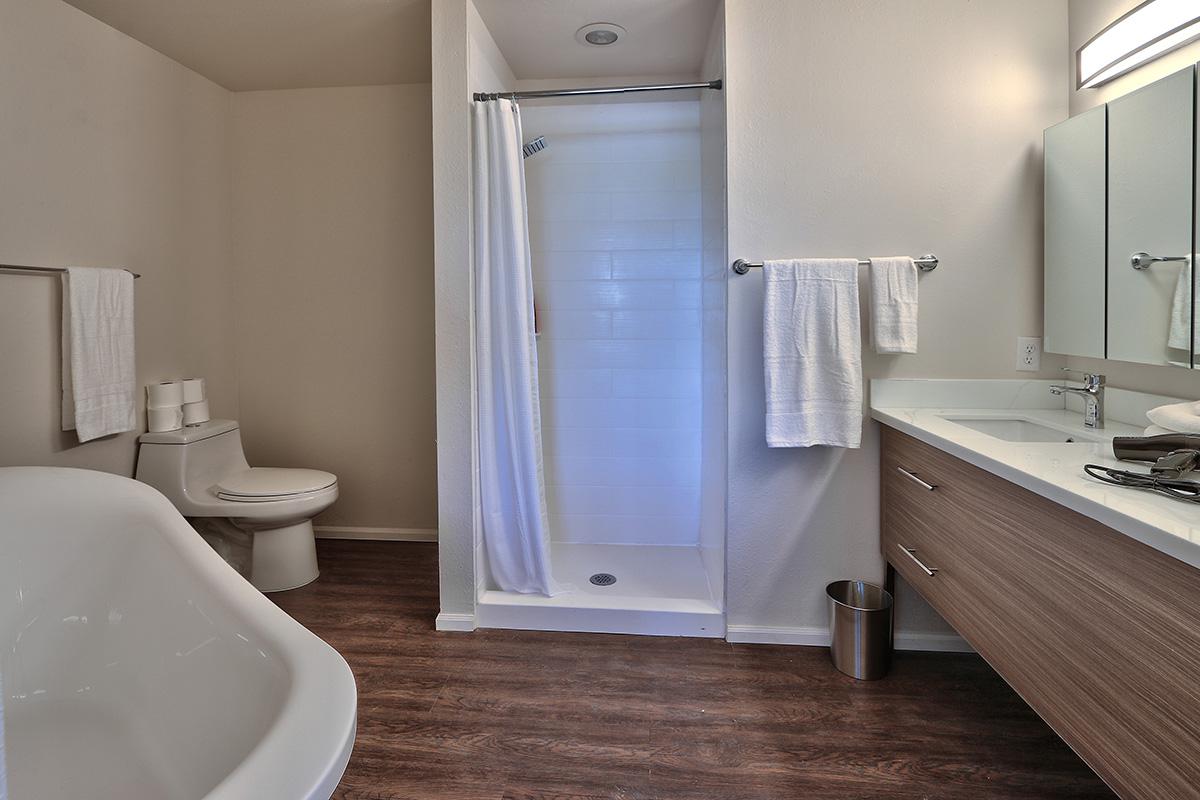 a white tub sitting next to a sink