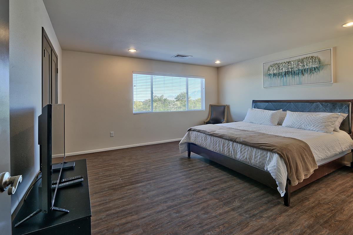 a bedroom with a bed and desk in a room