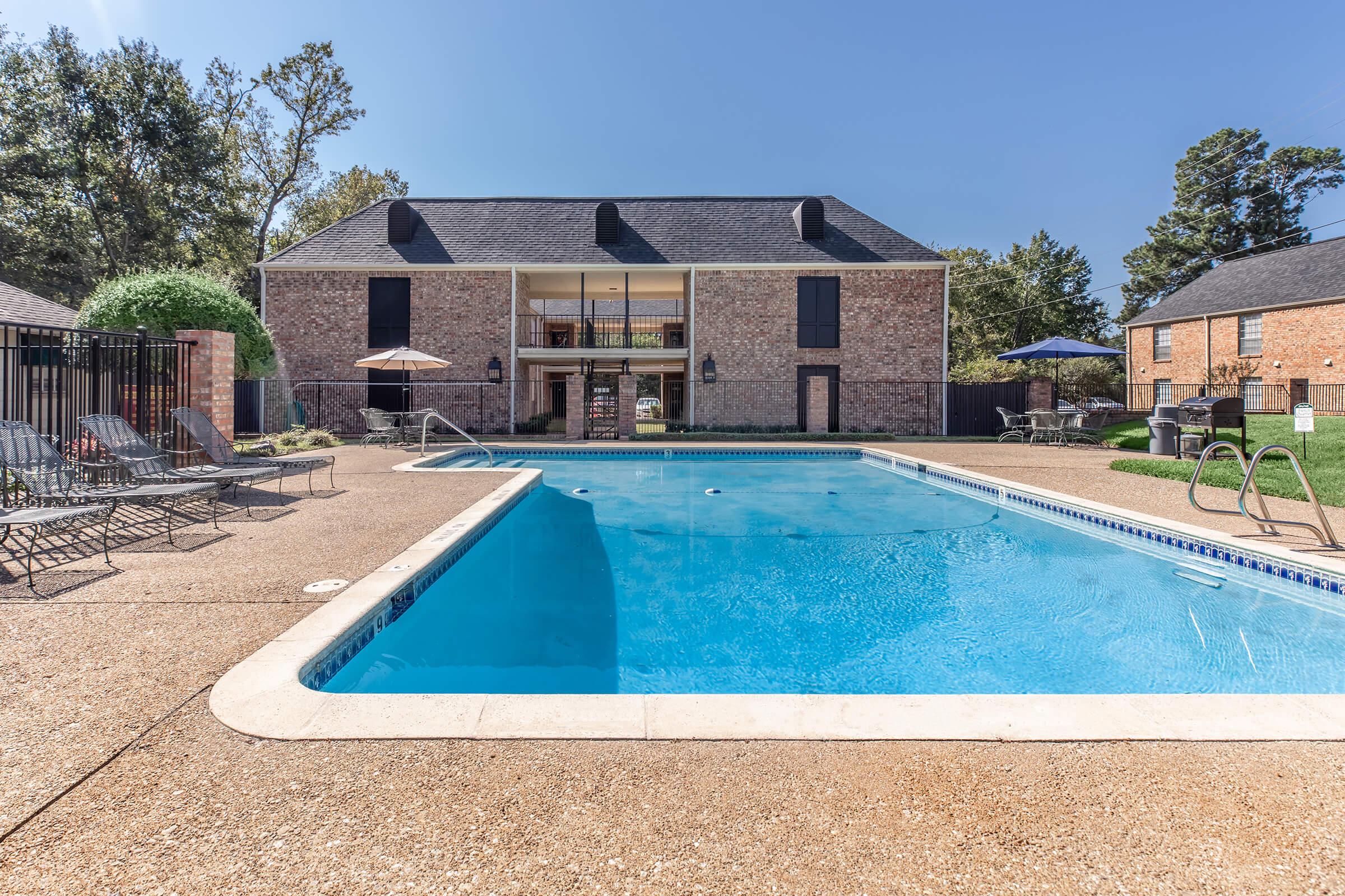 a house with a pool in front of a building