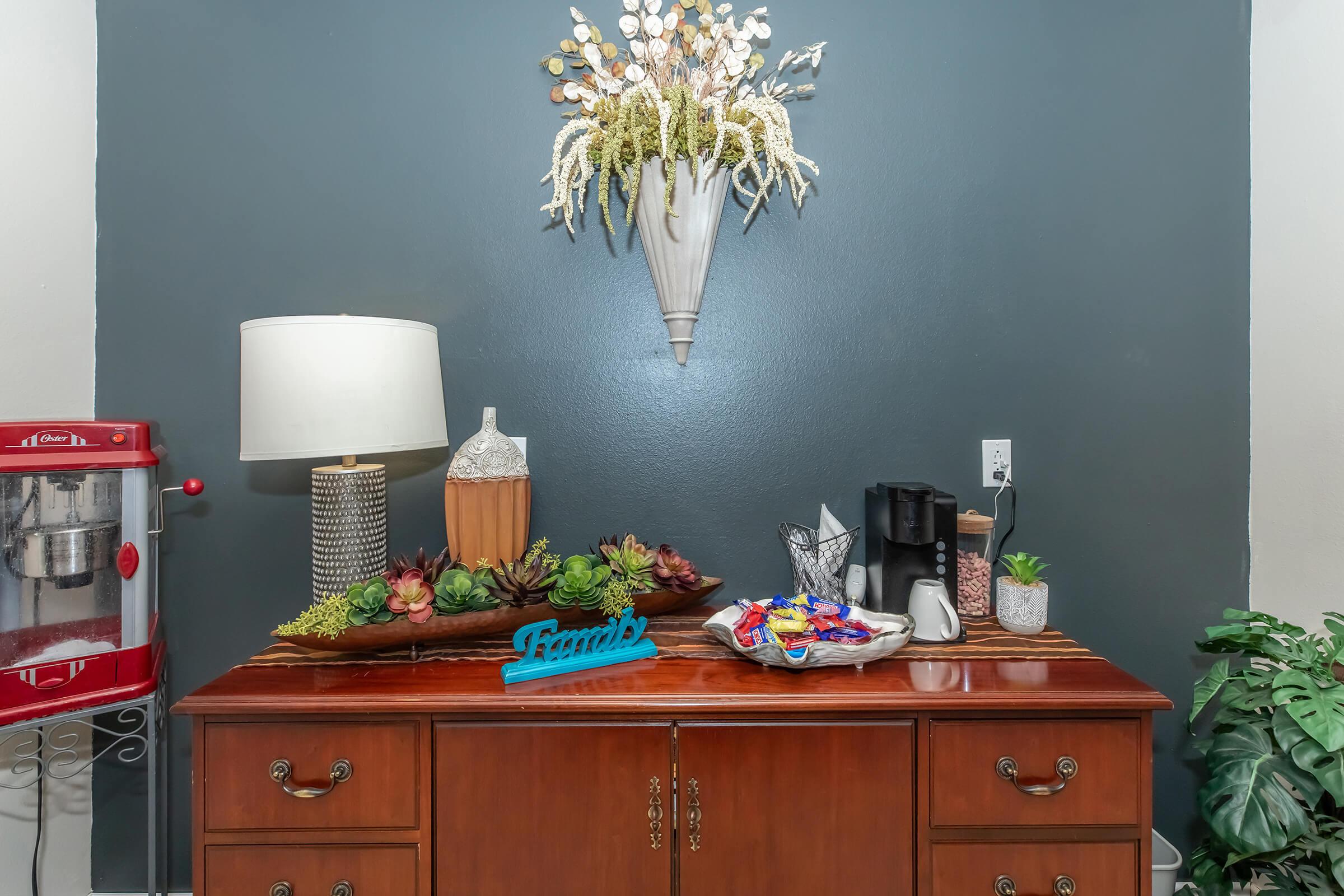 a room filled with furniture and vase of flowers on a table