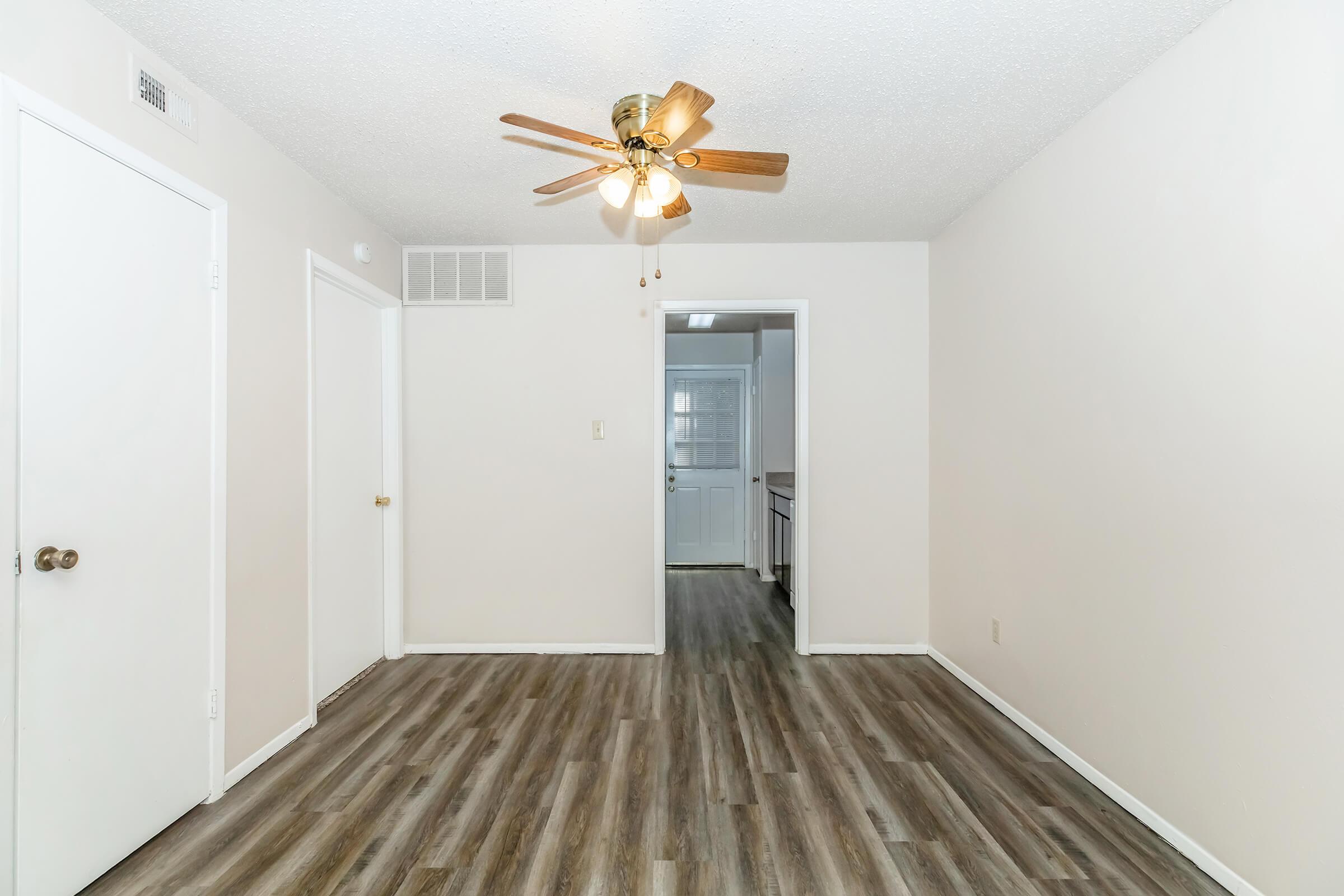 a large empty room with a wooden floor