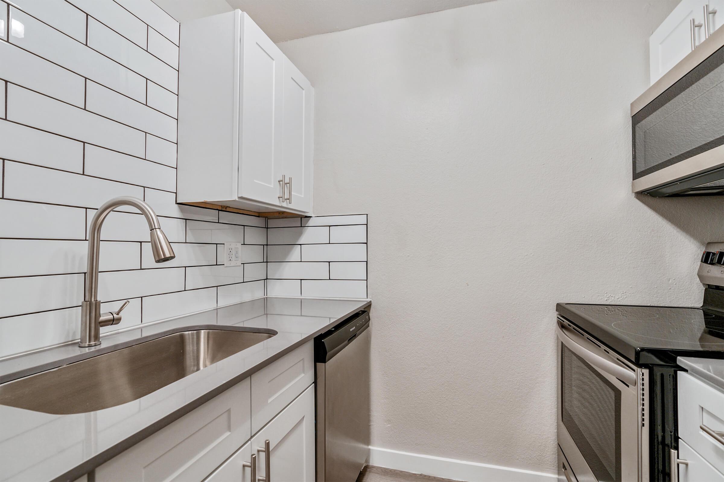 a kitchen with a sink and a mirror