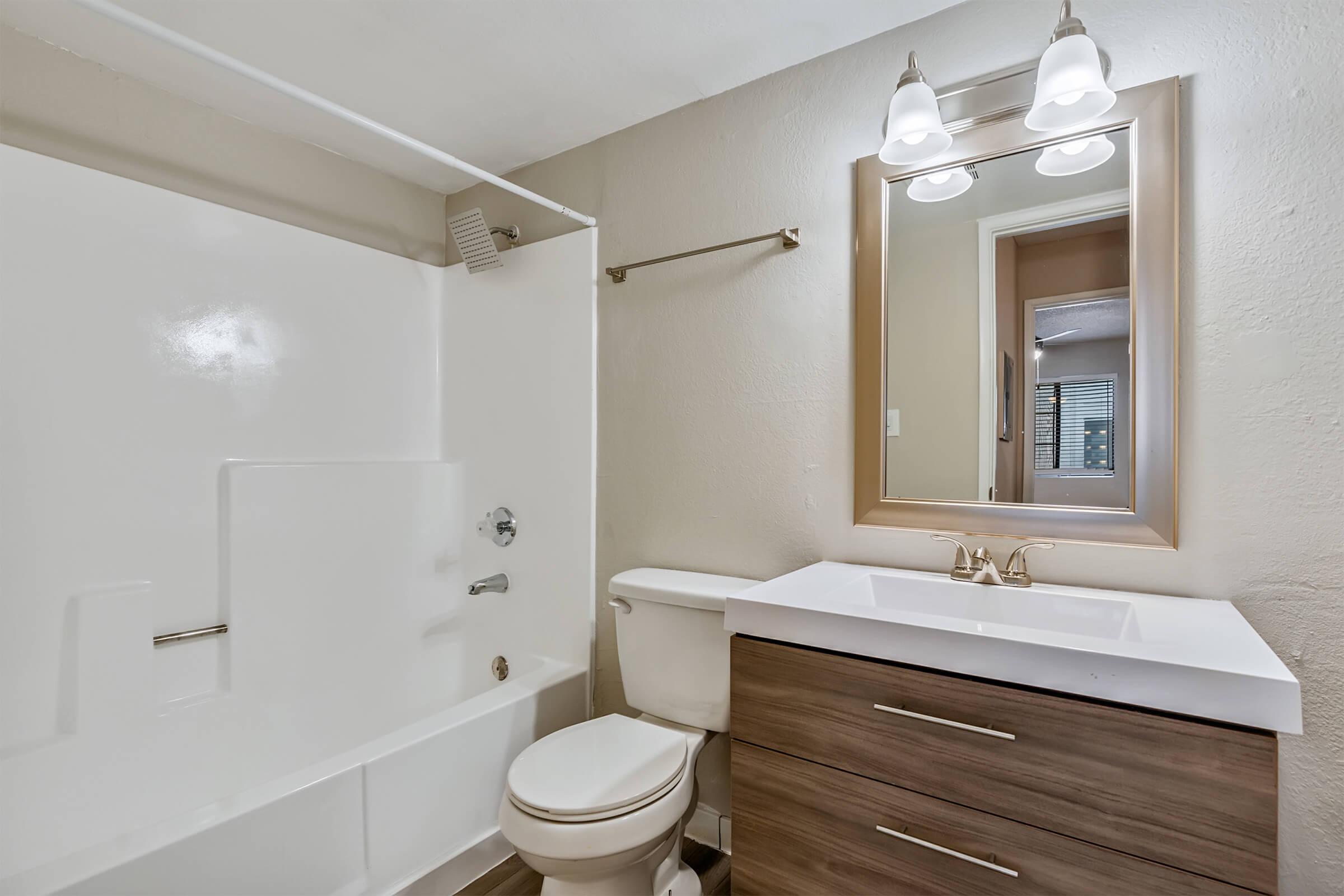 a room with a sink and a mirror
