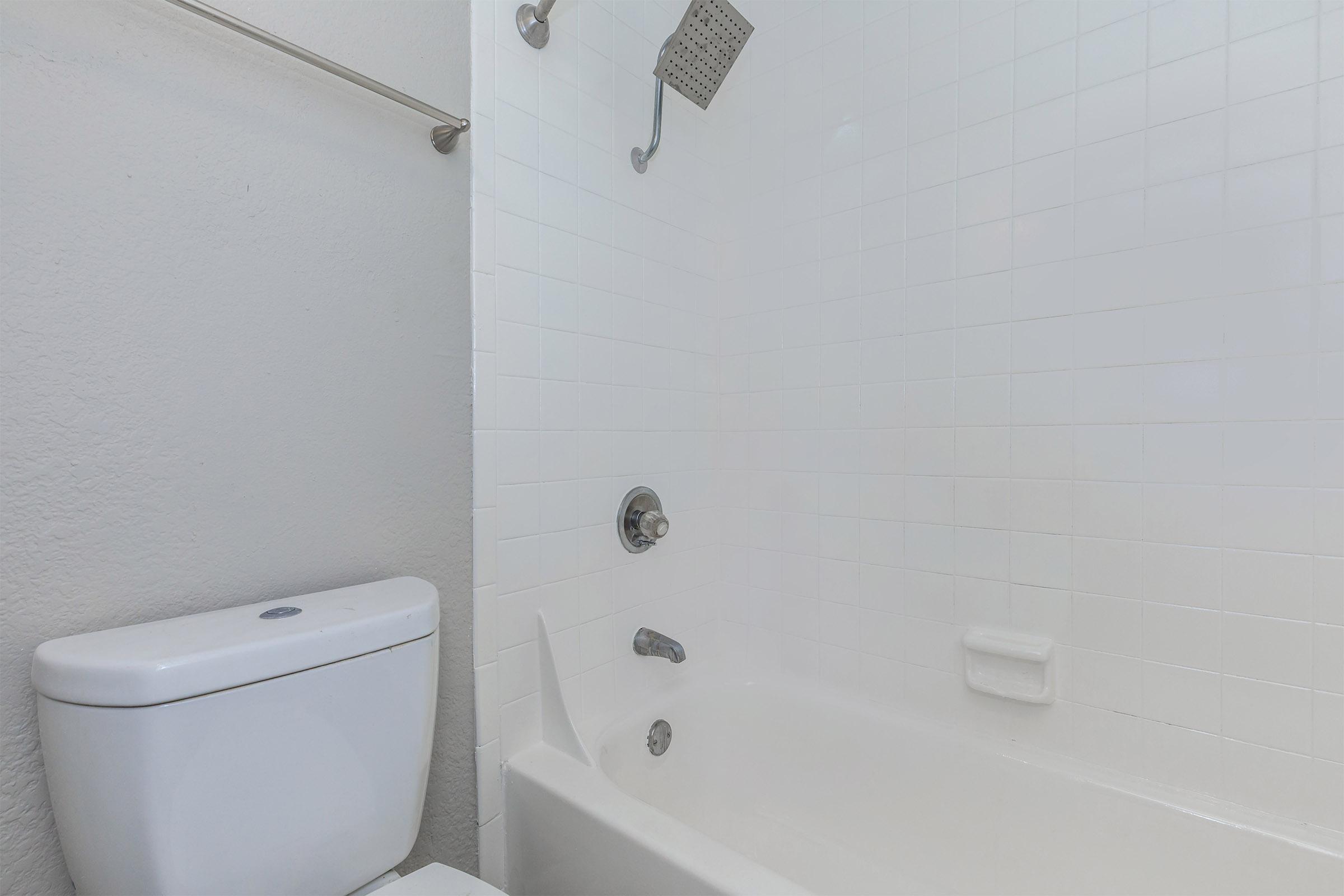 a white sink sitting under a mirror