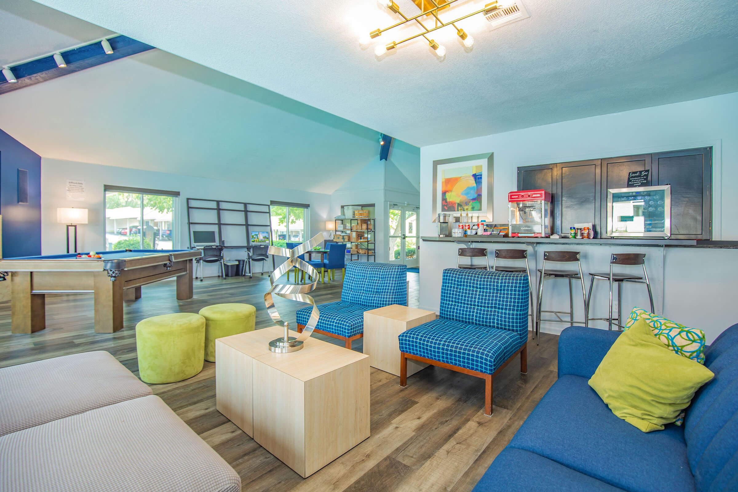 a living room filled with furniture and a large window