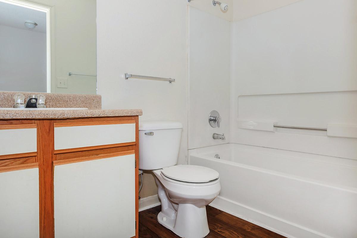 a white tub sitting next to a sink