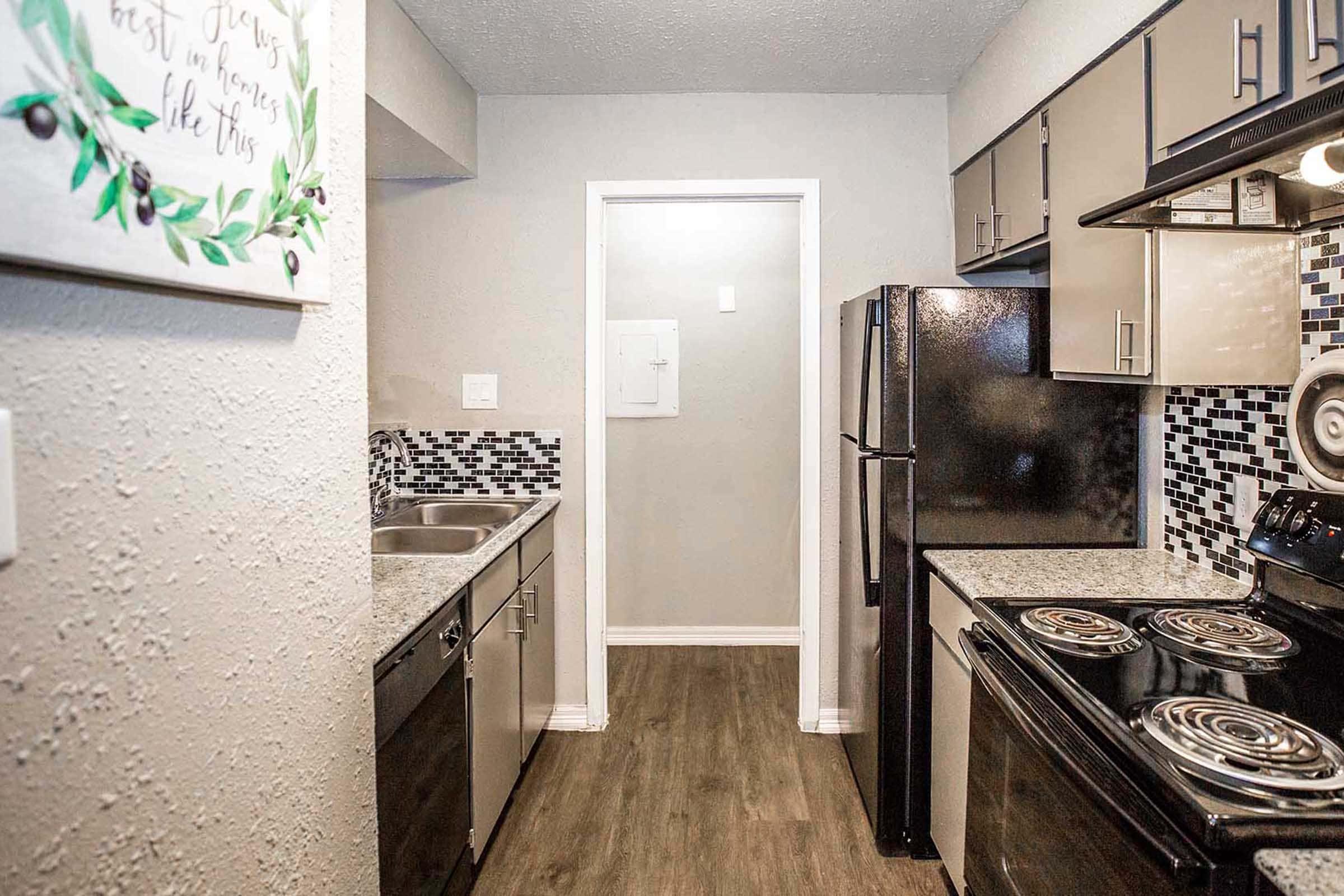 a kitchen area with a building in the background