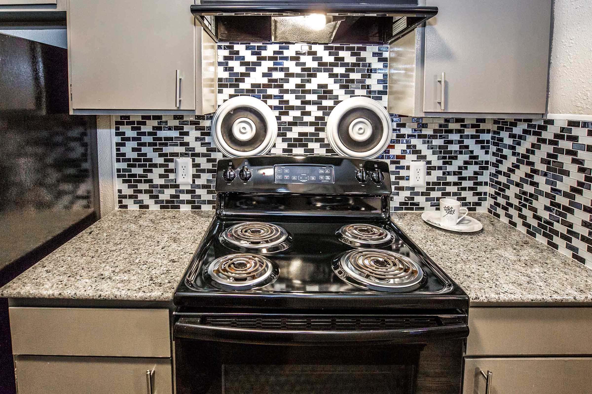 a stove top oven sitting inside of a kitchen