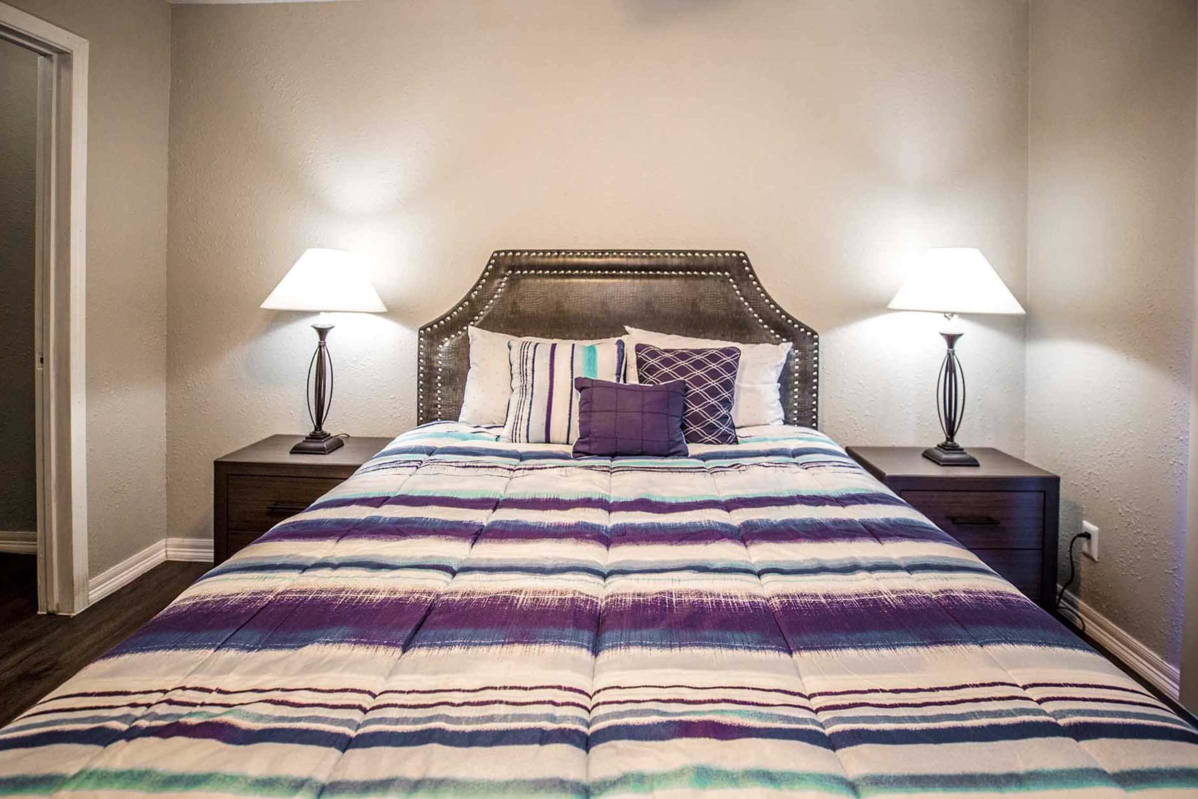 a bedroom with a large bed in a hotel room