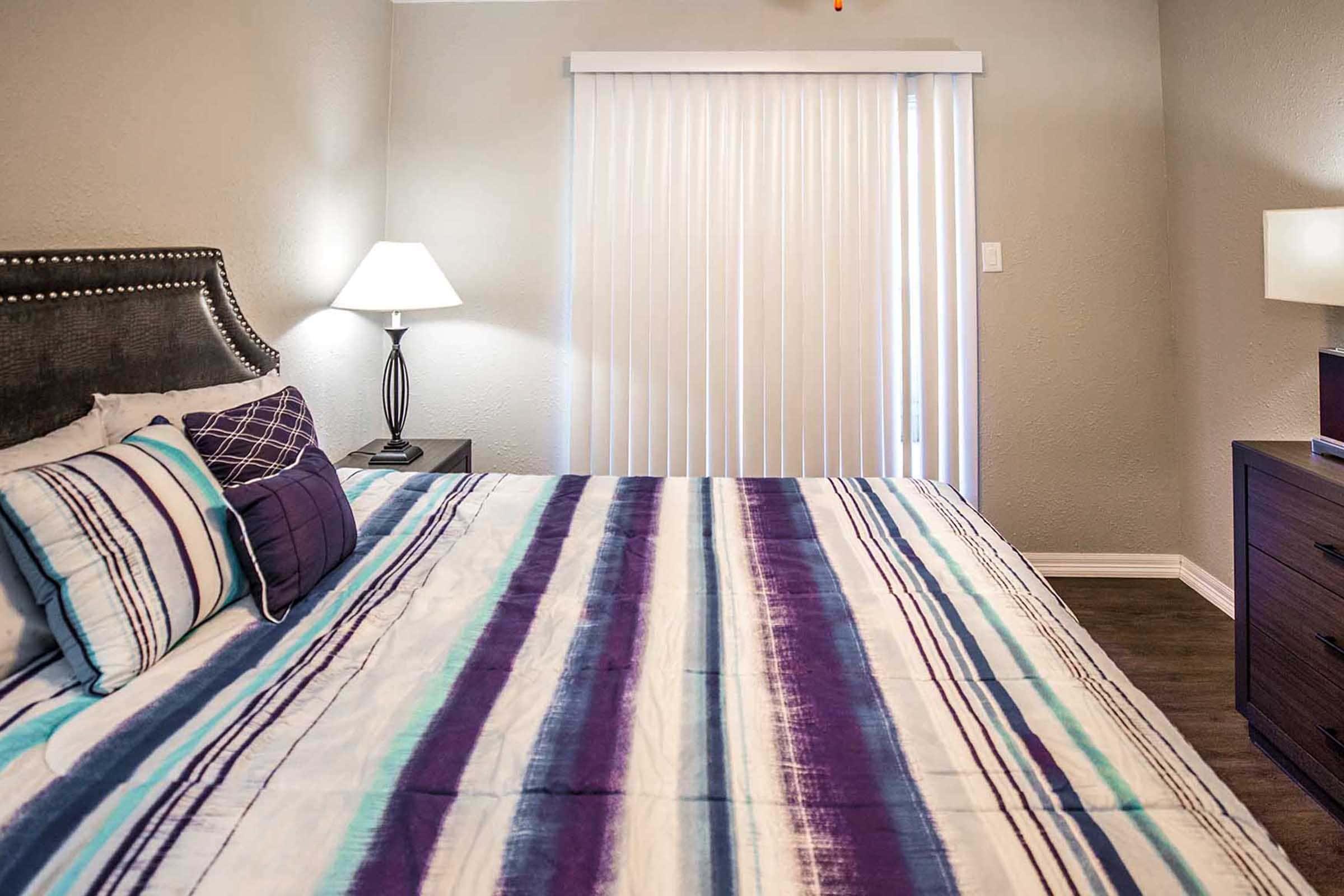 a bedroom with a large bed in a hotel room