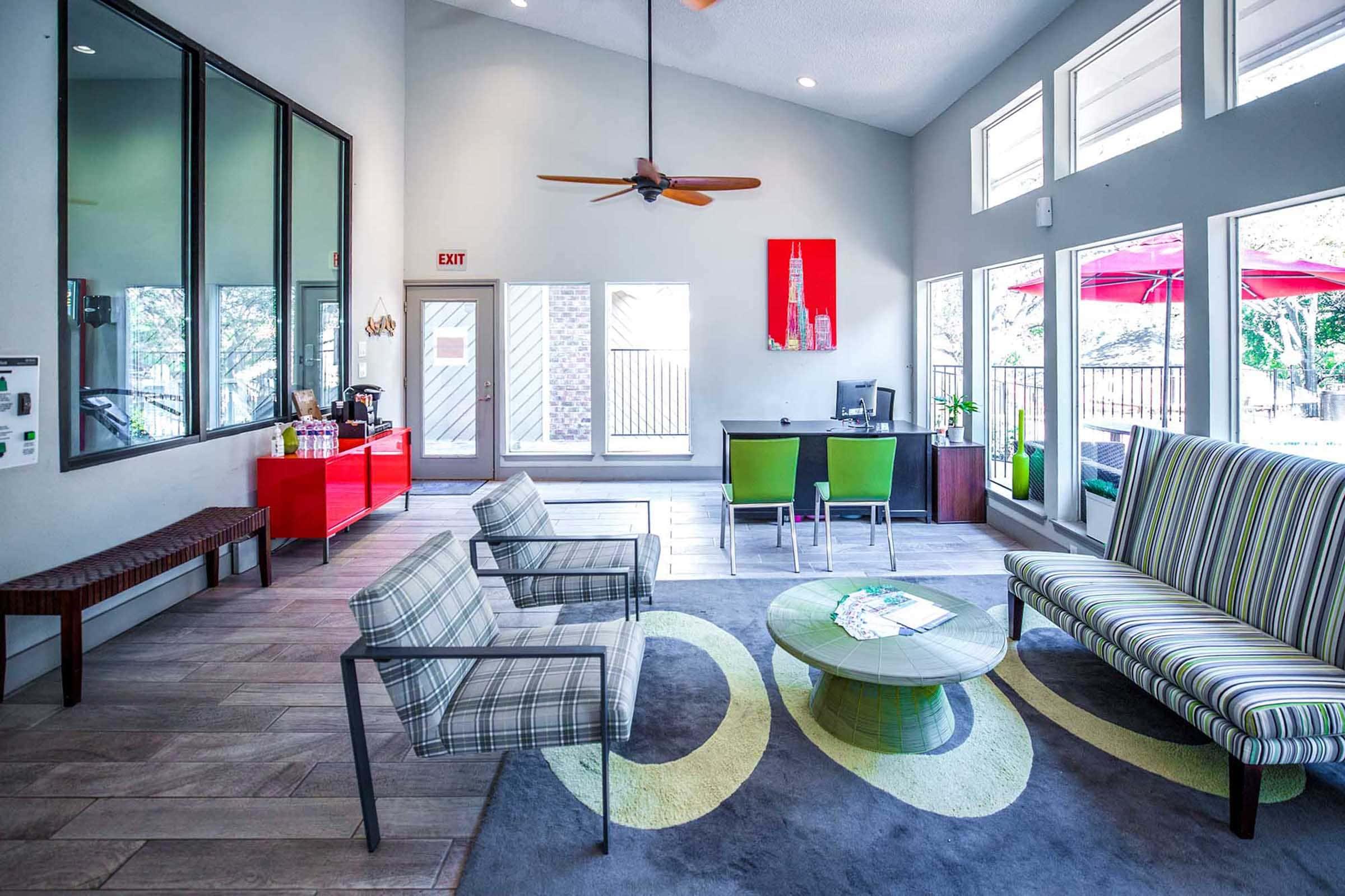 a living room filled with furniture and a large window